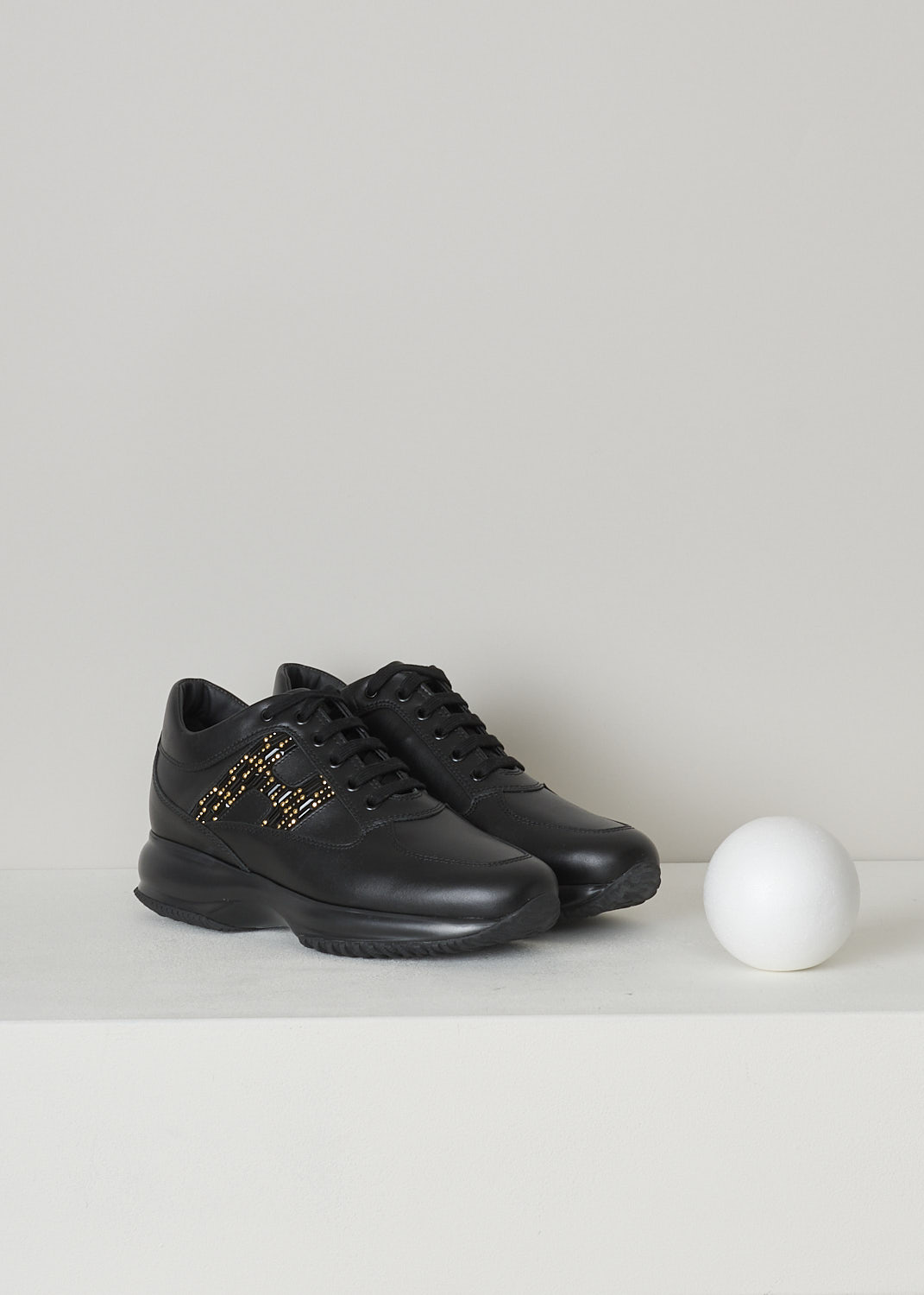 HOGAN, BLACK SNEAKERS WITH BEJEWELED H, HXW00N0BY00I85B999_I85_NERO, Black, Front, These black leather sneakers feature front lace-up fastening with black laces, a round shaped toe and a black rubber sole. The sneakers have the brand's H logo in on the sides in golden rhinestones. 
