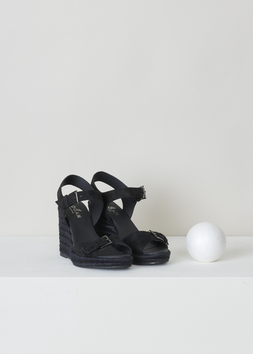 Hogan, Wedge heeled sandals, HXW5580DL20CR0B999_H558_CR0_nero, black silver, front, These lovely black wedge heeled sandals fills us all with summer vibes. Featuring a single strap over the vamp with an ornamental buckle also coloured black. The ankle strap however, has a functional buckle, it is coloured black and acts as your fastening option. 

Heel height: 11 cm / 4.3 inch. 