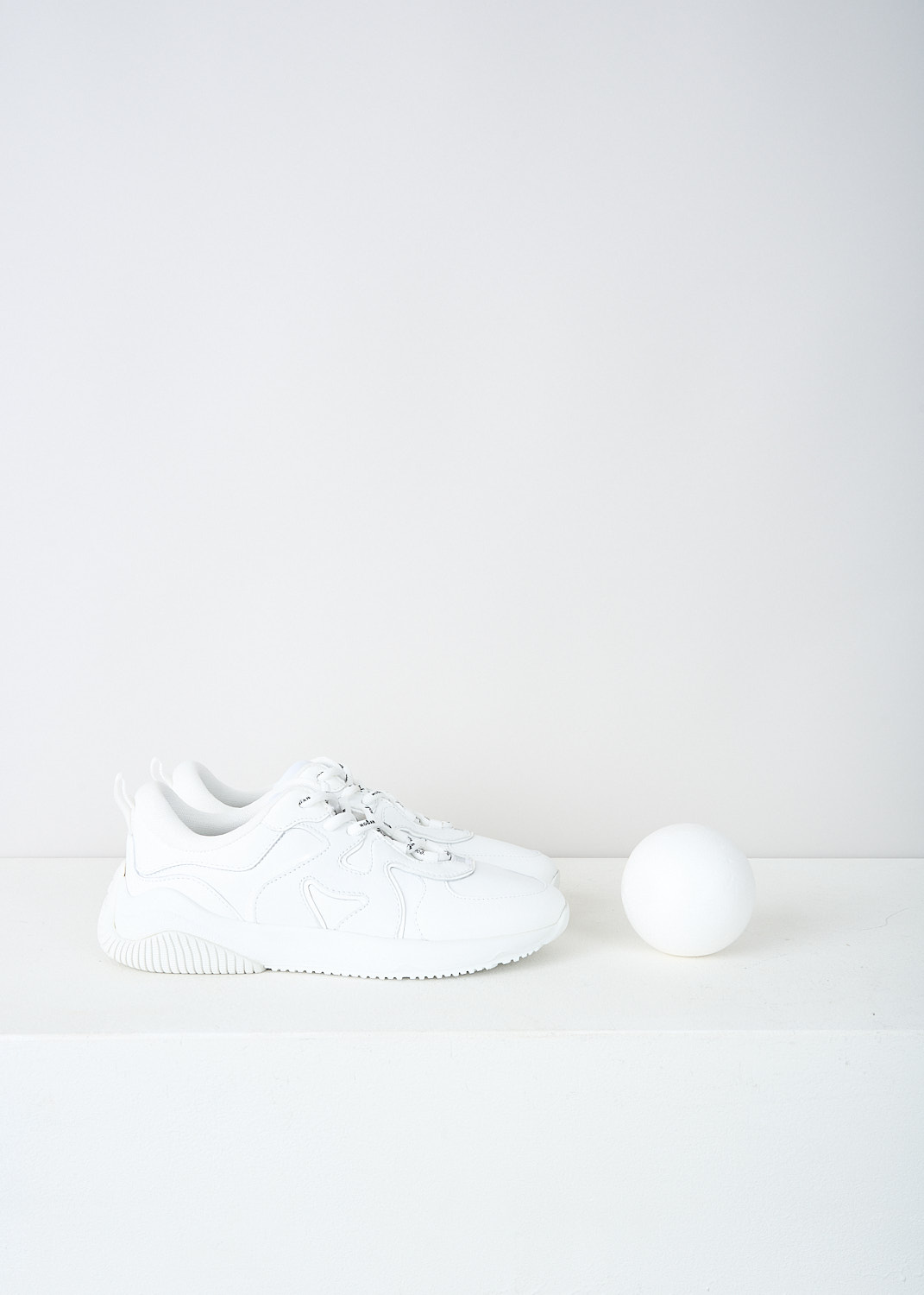 Hogan, All-white H597 sneakers, HXW5970EA90RF8B001, White, Side, These all-white low top H597 sneakers feature front lace-up fastening with white laces that have the brand's name printed on them in black. The brand's H logo is incorporated into the design on the sides. The sneakers have white rubber soles.  
