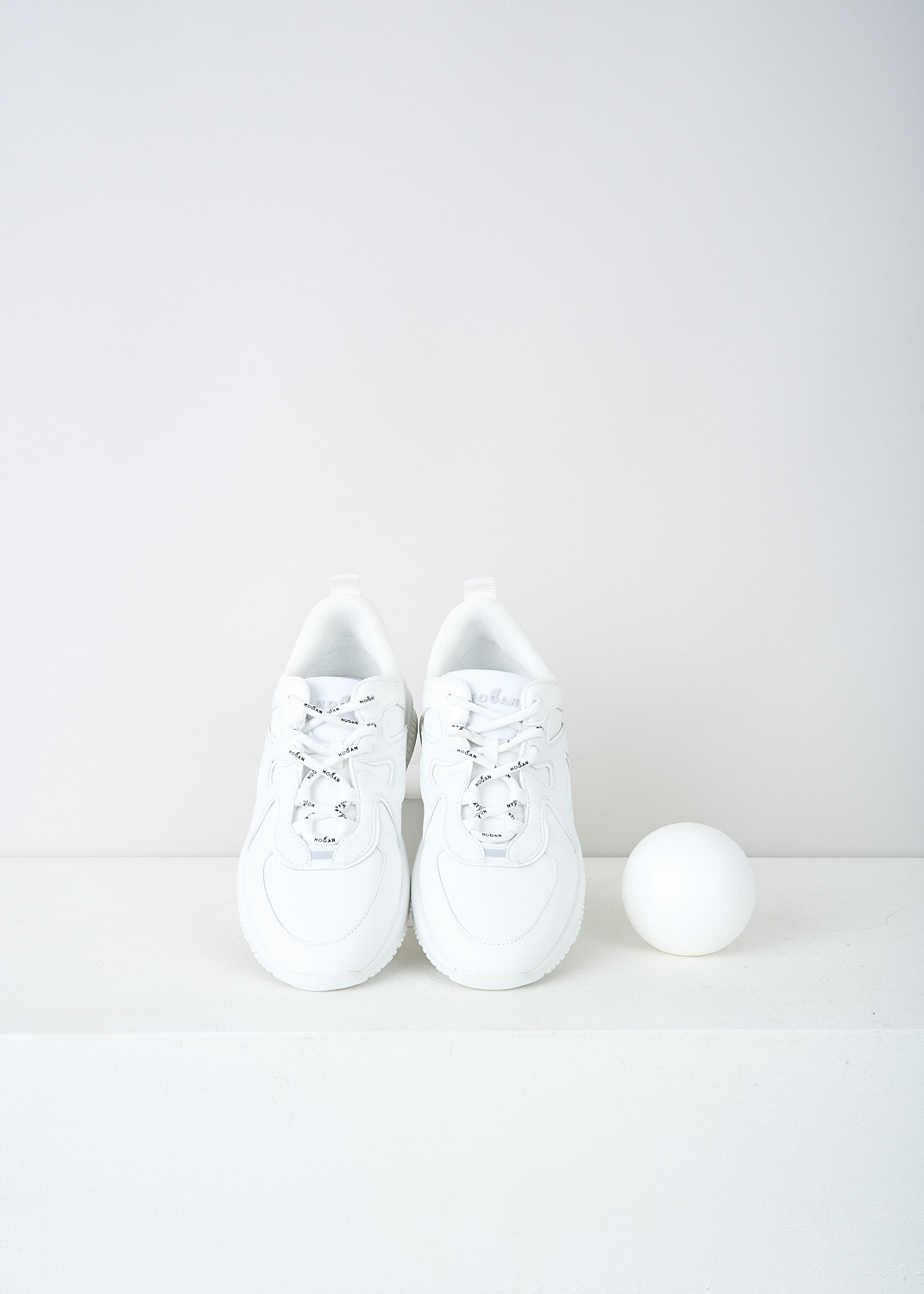 Hogan, All-white H597 sneakers, HXW5970EA90RF8B001, White, Top, These all-white low top H597 sneakers feature front lace-up fastening with white laces that have the brand's name printed on them in black. The brand's H logo is incorporated into the design on the sides. The sneakers have white rubber soles.  
