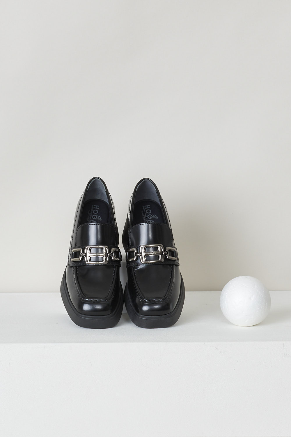 HOGAN, BLACK HEELED MOCCASINS, HXW6180EP40RWWB999_H618_MOCASSINO_ACCESSORIO, Black, Top, These slip-on loafers have a squared off toe with toe stitching and an silver-tone H-shaped buckle over the upper side. The loafers have a chunky black sole. 

