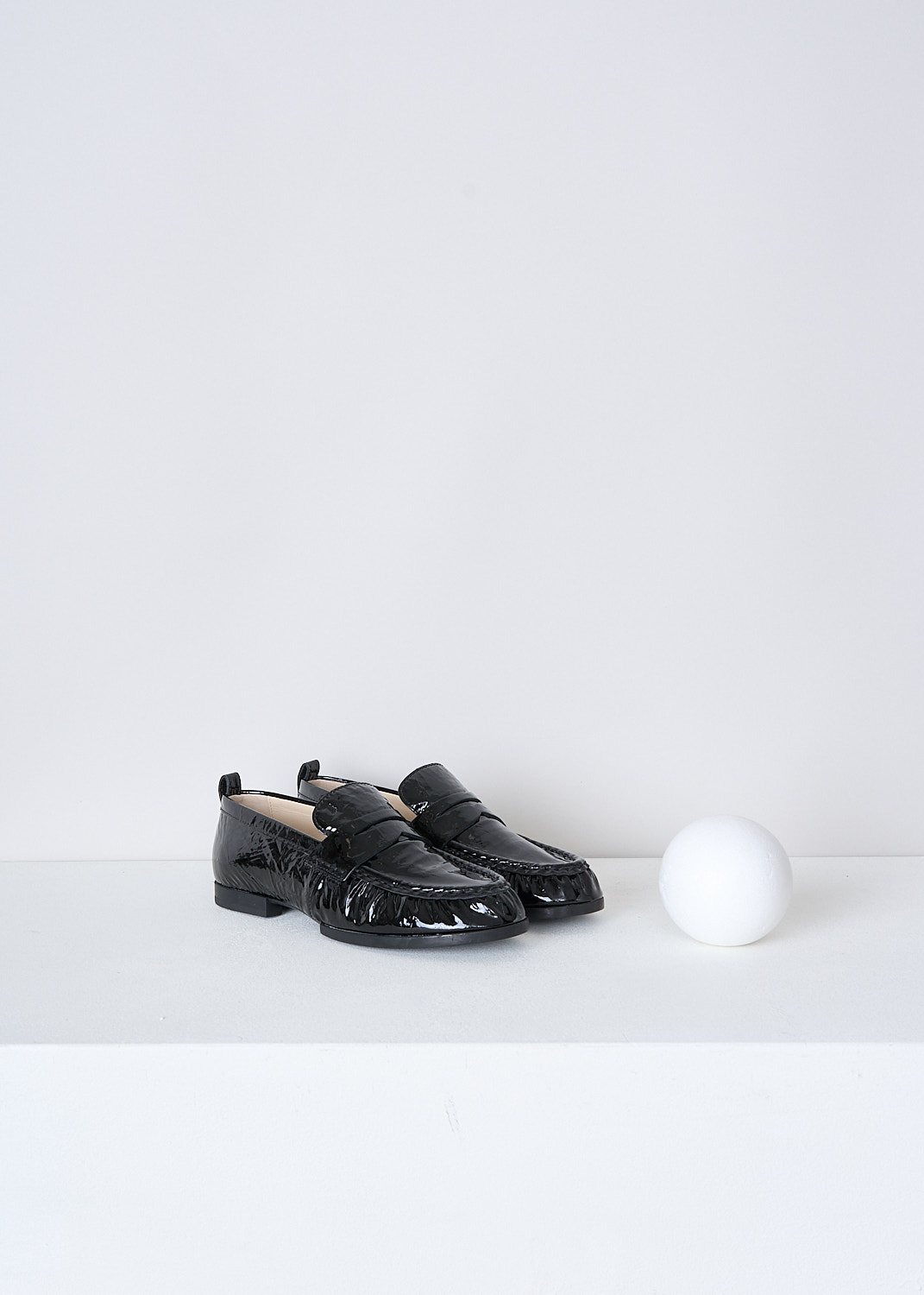 TODS, BLACK LACQUER LOAFERS, XXW02E0EC60QWIB99, Black, Front, These black lacquer slip-on penny loafers have a rounded toe and a decorative slotted leather strip over the upper side. Around the trim, the leather is subtly pleated. These loafers have black soles.
