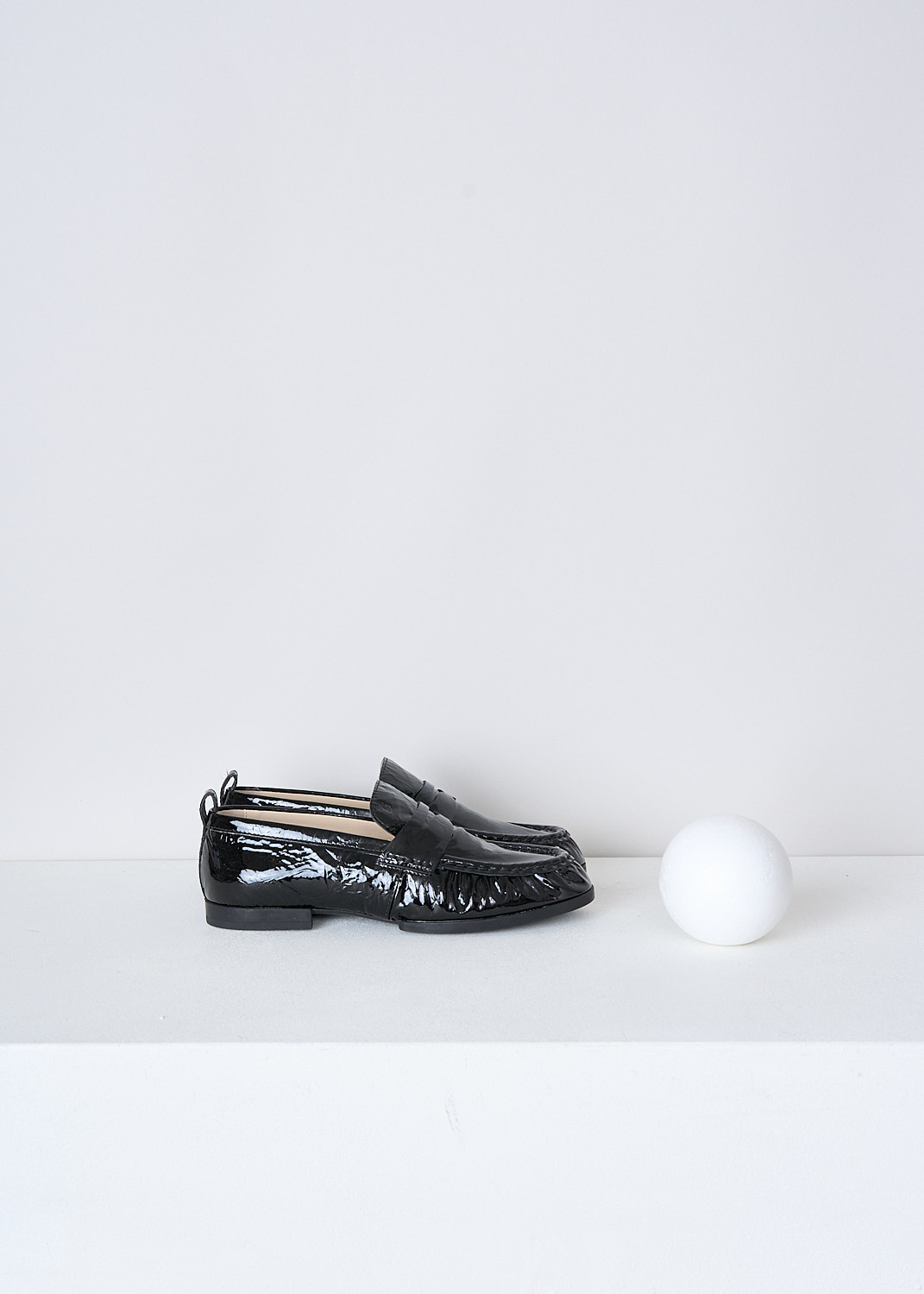 TODS, BLACK LACQUER LOAFERS, XXW02E0EC60QWIB99, Black, Side, These black lacquer slip-on penny loafers have a rounded toe and a decorative slotted leather strip over the upper side. Around the trim, the leather is subtly pleated. These loafers have black soles.
