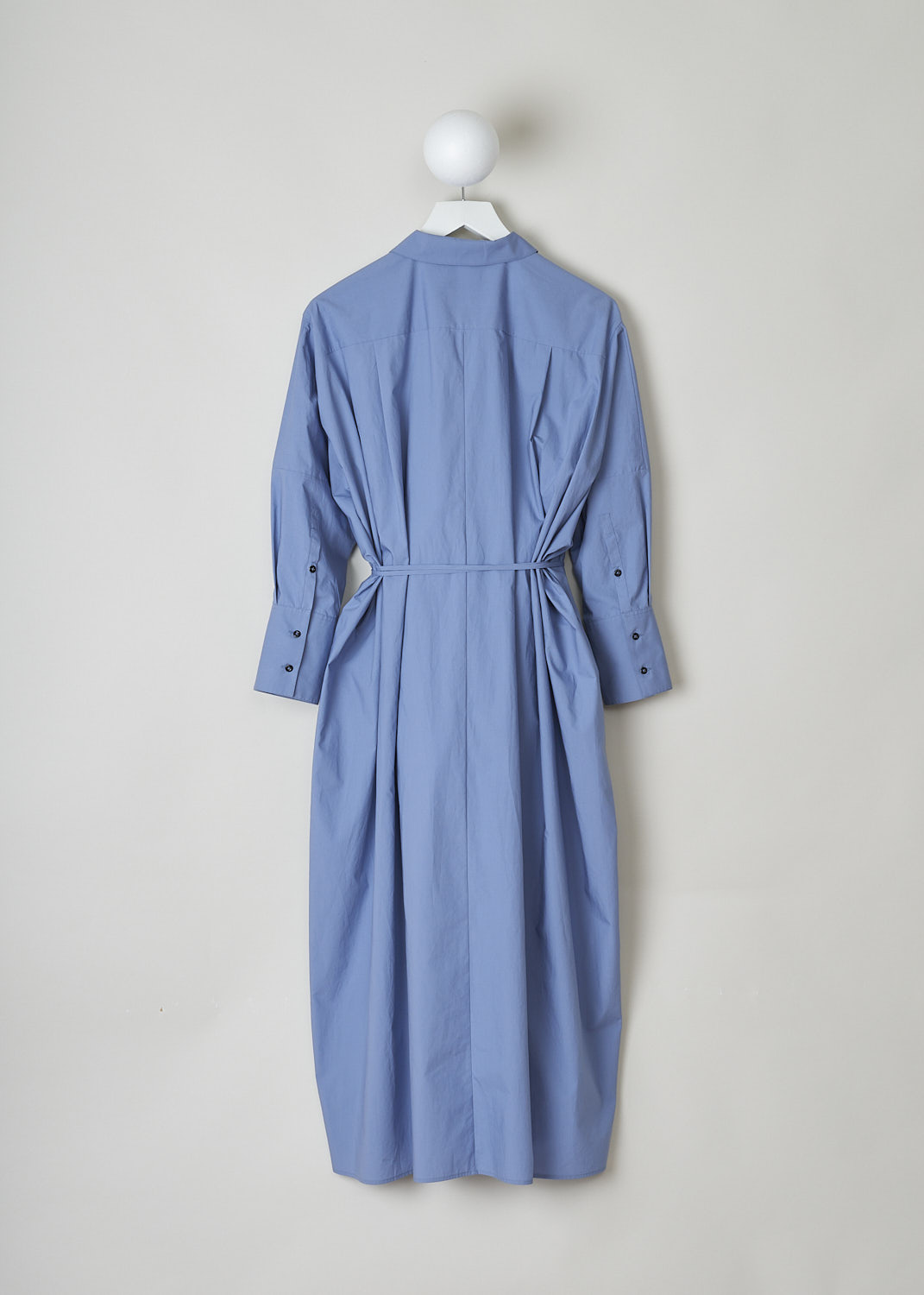 JIL SANDER, BLUE MIDI SHIRT DRESS WITH WAIST TIE, JSPO500806_WO242000_450, Blue, Back, This blue midi shirt dress has a spread collar with a straight neckline. The dress has a concealed front button closure with a single black button visible. The dress has three quarter sleeves with buttoned cuffs. The A-line silhouette can be cinched in with ties. Slanted pockets are concealed in the side seams. The dress has an asymmetrical finish, meaning the back is longer than the front.

