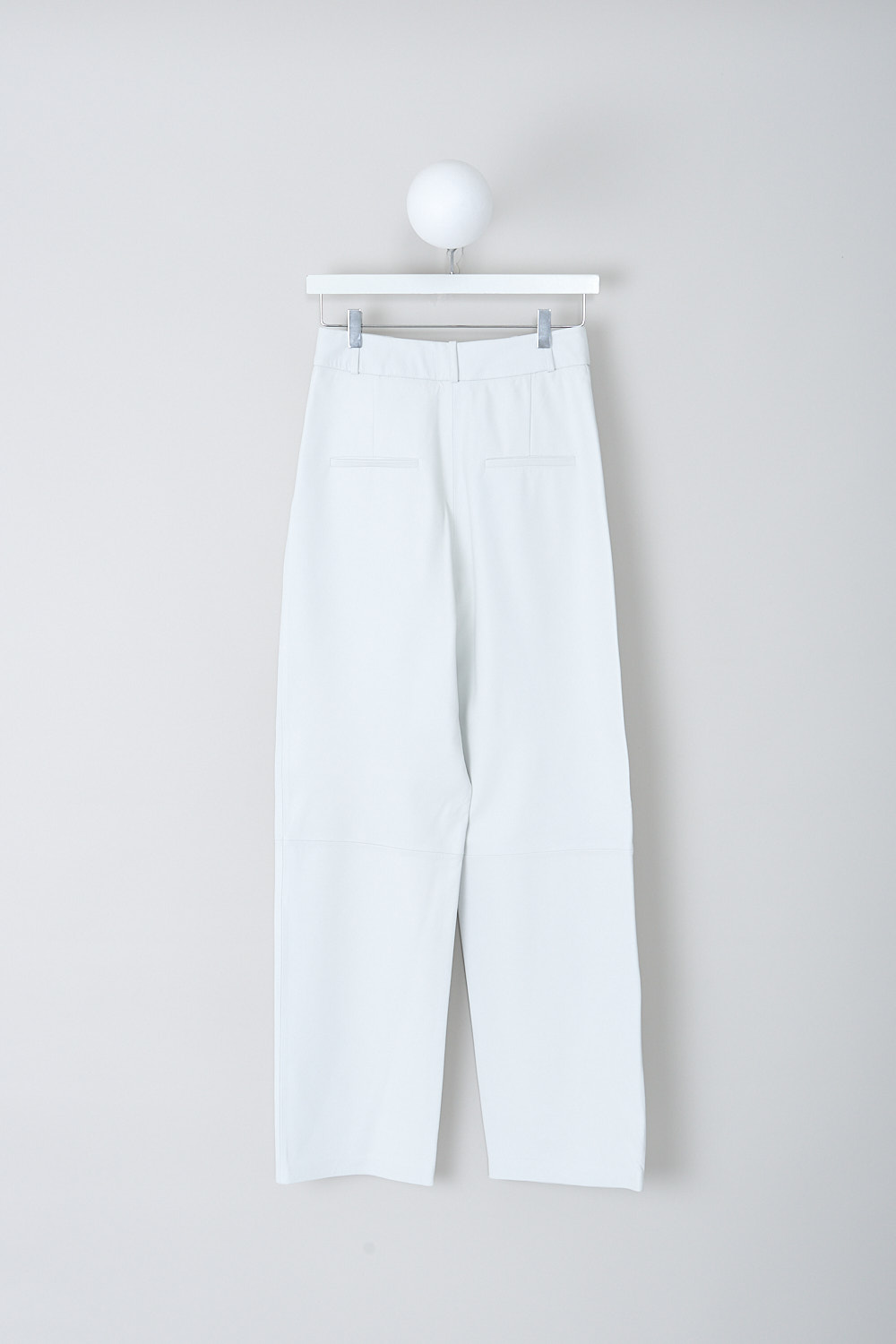 KASSL, WHITE LEATHER PANTS, R01230000W_RTW_TROUSERS_SOFT_LEATHER_WHITE, White, Back, These high-waisted white leather pants have a waistband with belt loops and a concealed clasp and zip closure. In the front, these pants have slanted front pockets. The straight pant legs have a decorative seam at knee-hight and a straight hemline. In the back, the pants have welt pockets.   
