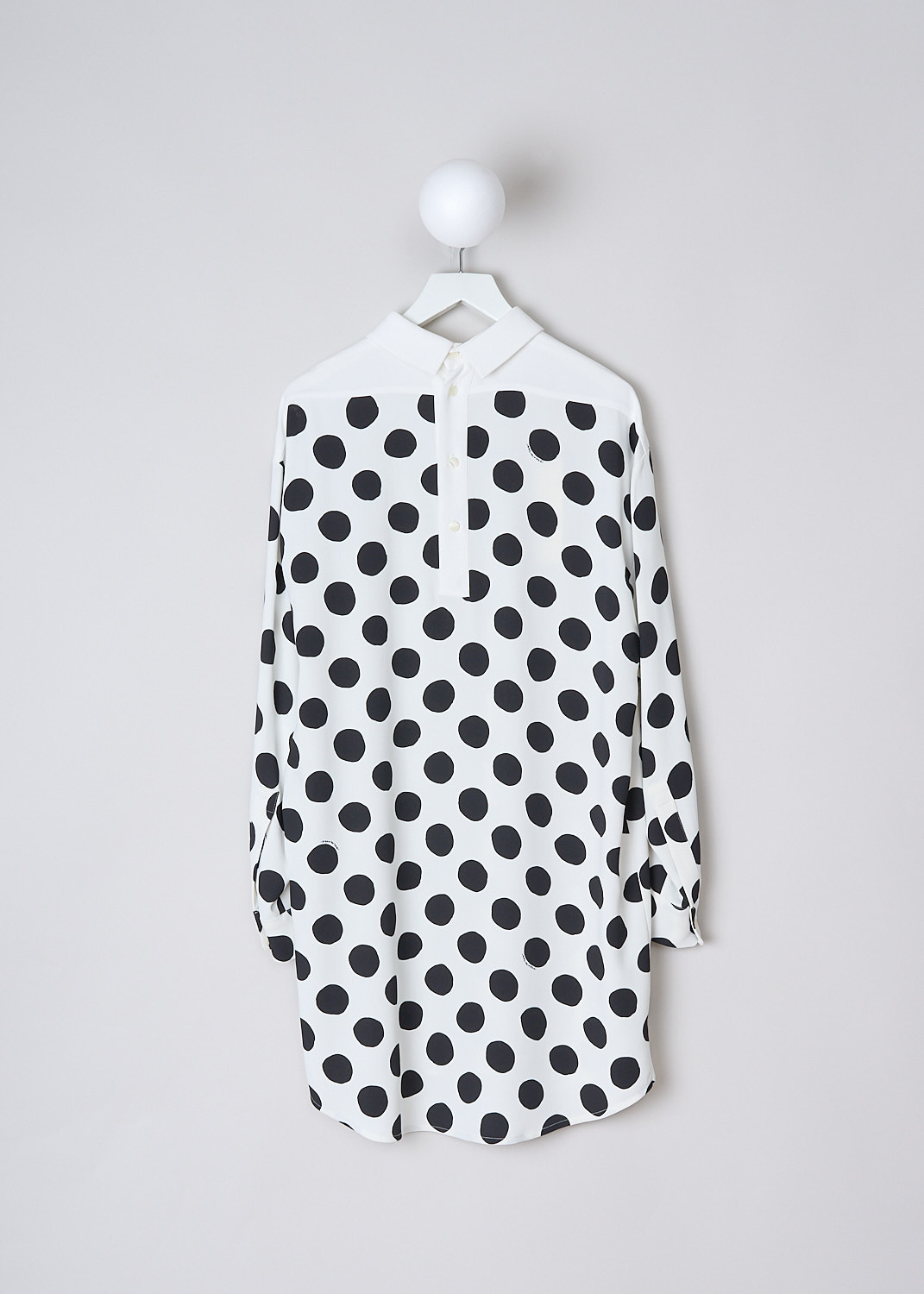 MARNI, BIG DOT LONG SLEEVE MIDI DRESS, ABMA1141Q0_UTV996_BDW03, Black, White, Print, Back, This Big Dot long sleeve midi dress has a white base color with a black big dots-print. The front and back yoke are plain white. The dress has a classic collar. The long sleeves have buttoned cuffs. In the back, a row of four buttons functions as the closure.  The dress has a high-low hem.
