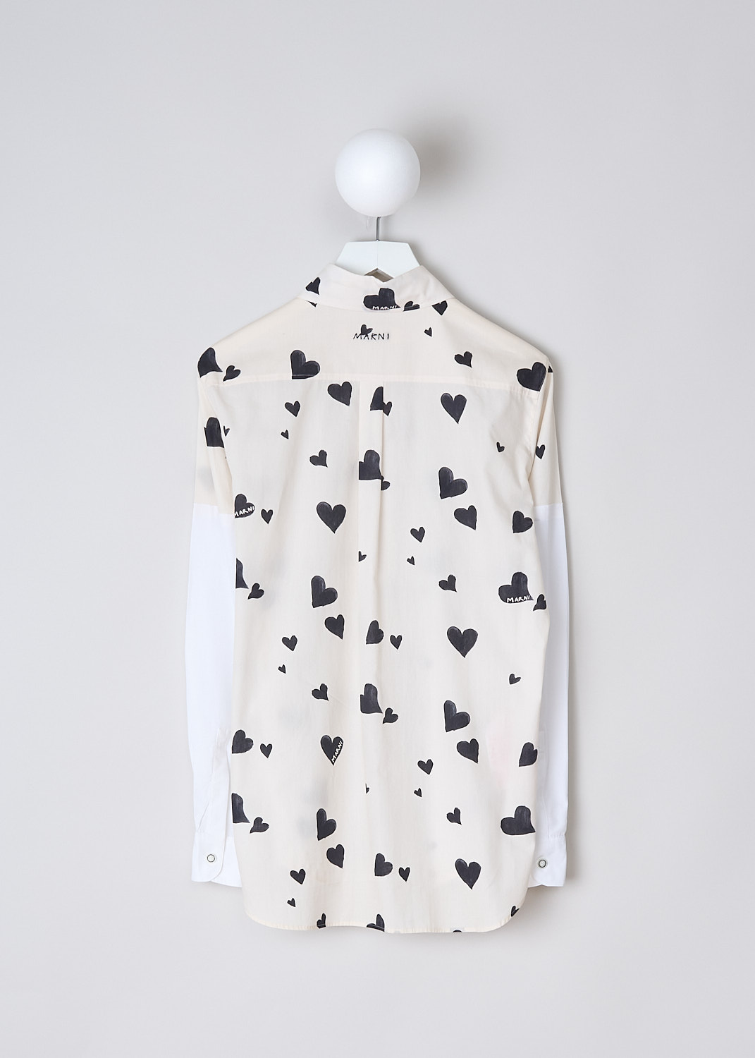 MARNI, BUNCH OF HEARTS POPLIN BLOUSE, CAMA0544QS_UTC280_BHW03, Black, White, Print, Back, This Bunch of Hearts poplin blouse in stone white has an all-over heart print. The blouse has a spread collar, a front button closure and a single breast pocket. The long crisp white sleeves have buttoned cuffs. The brand's logo is embroidered in black on the back of the neck. The rounded hemline has an asymmetric finish, with the back being slightly longer than the back. 
