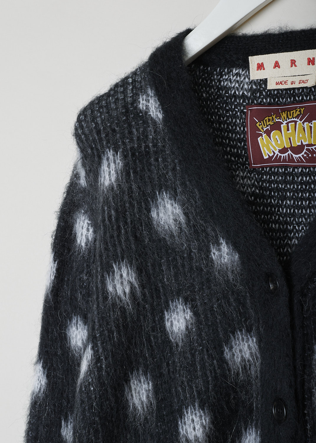 MARNI, BRUSHED DOTS FUZZY WUZZY CARDIGAN, CDMD0326Q0_UFU160_DON99, Black, Print, Grey, Detail, This brushed dots Fuzzy Wuzzy cardigan has a black V-neckline with a front button closure. The sweater has a two-tone dot pattern in black and grey. The long balloon sleeves have ribbed cuffs. That same ribbed finish can be found on the hemline.
