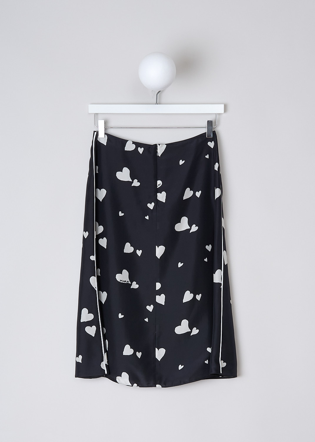 MARNI, BUNCH OF HEARTS SILK SKIRT, GOMA0580I0_UTSG03_BHN99, Black, White, Print, Back, This Bunch of Hearts silk midi skirt has a black base color with a white heart print. White piping runs along the side seams. The skirt has an A-line silhouette with a straight hemline. In the back, a concealed centre zip functions as the closure. The skirt is fully lined. 
