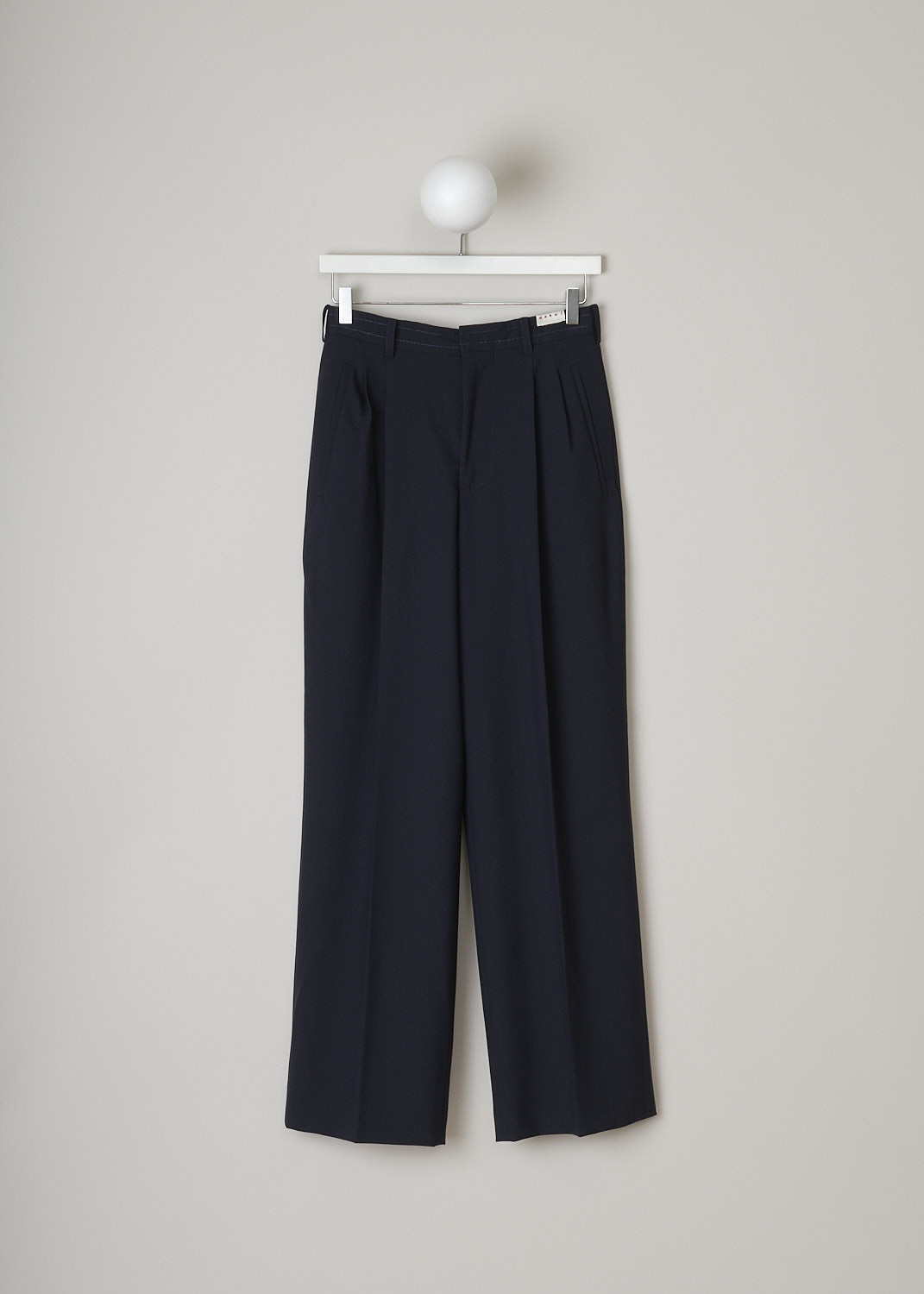 MARNI, DARK NAVY HIGH-WAISTED PANTS, PAMA0385U2_TW839_00B99, Blue, Front, These dark navy high-waisted pants have a waistband with belt loops. In the front, the brand's logo patch is attached on the waistband.
The pants has slanted welt pockets. Centre pleats run along the length of the wide pants legs. In the back, these pants have two welt pockets: one with flap and button. 
  
