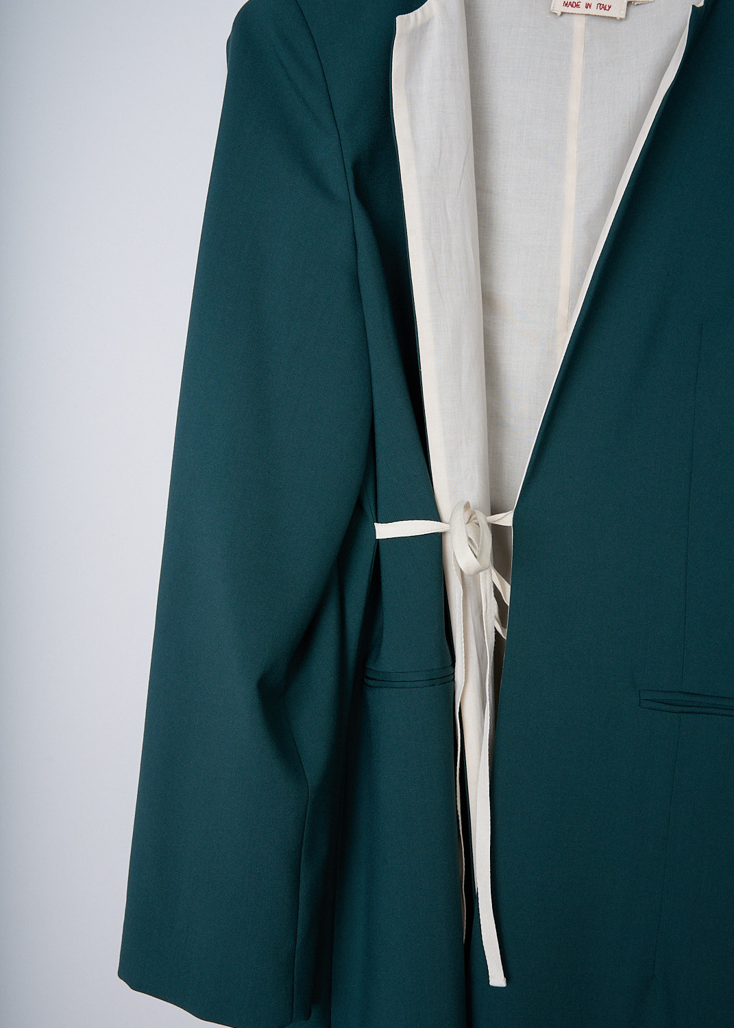 MARNI, GREEN JACKET WITH TIE CORD, SPMA0182U0_TW839_00V93, Green, Detail, This long green coat has a round collarless neckline. The front is open with a tie cord to one side. Also on the front, the coat has welt pockets. The coat is fully lined with a off-white cotton fabric that peeks out from under the hemline.

