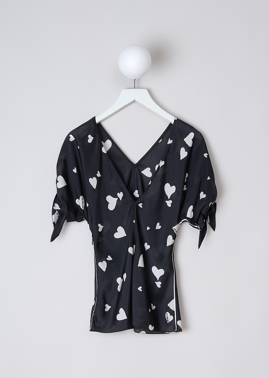 MARNI, BUNCH OF HEARTS SILK TOP, TTMA0264I0_UTSG03_BHN99, Black, White, Print, Back, This Bunch Of Hearts silk top has a black base color with a white heart print. The top has a V-neckline and short sleeves with tie cuffs. White pipping runs along the side seams. To one side, a zip is concealed in the side seams. The top has a deep V back. 
