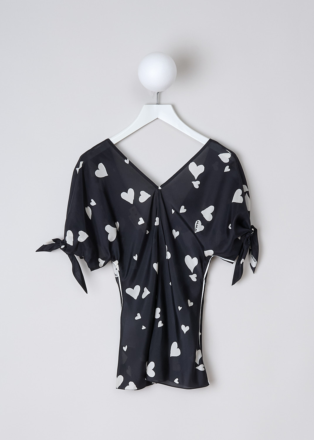 MARNI, BUNCH OF HEARTS SILK TOP, TTMA0264I0_UTSG03_BHN99, Black, White, Print, Front, This Bunch Of Hearts silk top has a black base color with a white heart print. The top has a V-neckline and short sleeves with tie cuffs. White pipping runs along the side seams. To one side, a zip is concealed in the side seams. The top has a deep V back. 
