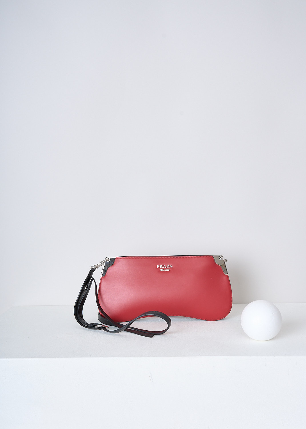 PRADA, BRIGHT RED CROSSBODY BAGUETTE BAG, 2AIX_CITY_CALF_1BH111_F0C9F_FUOCO_NERO, Red, Front, This red leather baguette bag has silver-tone hardware with the brand's lettering on the front in silver-tone metal. The bag has a zip closure that opens up to the main compartment. The compartment has a single slit pocket. The bag has a detachable black leather cross body strap which is adjustable in length. 

