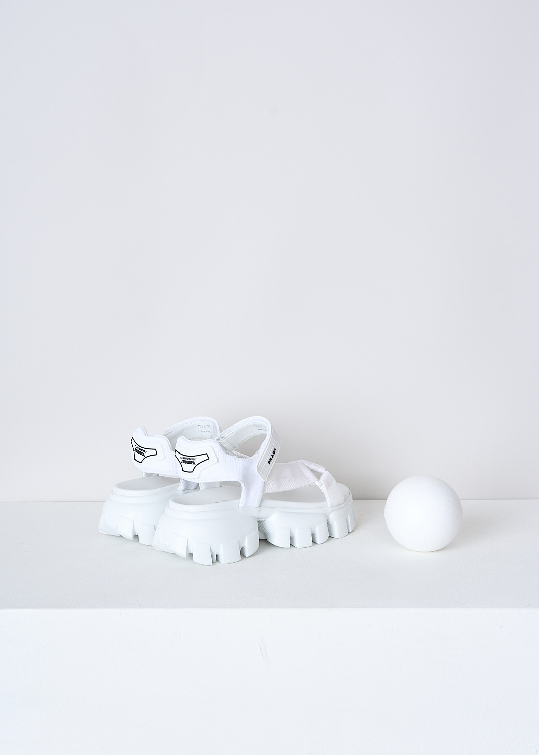 PRADA, WHITE SANDALS WITH CHUNKY SOLES, 1X037M_3L6W_F0009_NASTRO_MAGLIA_BIANCO, White, Back, These white sporty sandals have an adjustable velcro ankle strap with the brand's logo on in in black and white fabric straps across the vamp. These sandals have a round open-toe and chunky ridged soles. 
