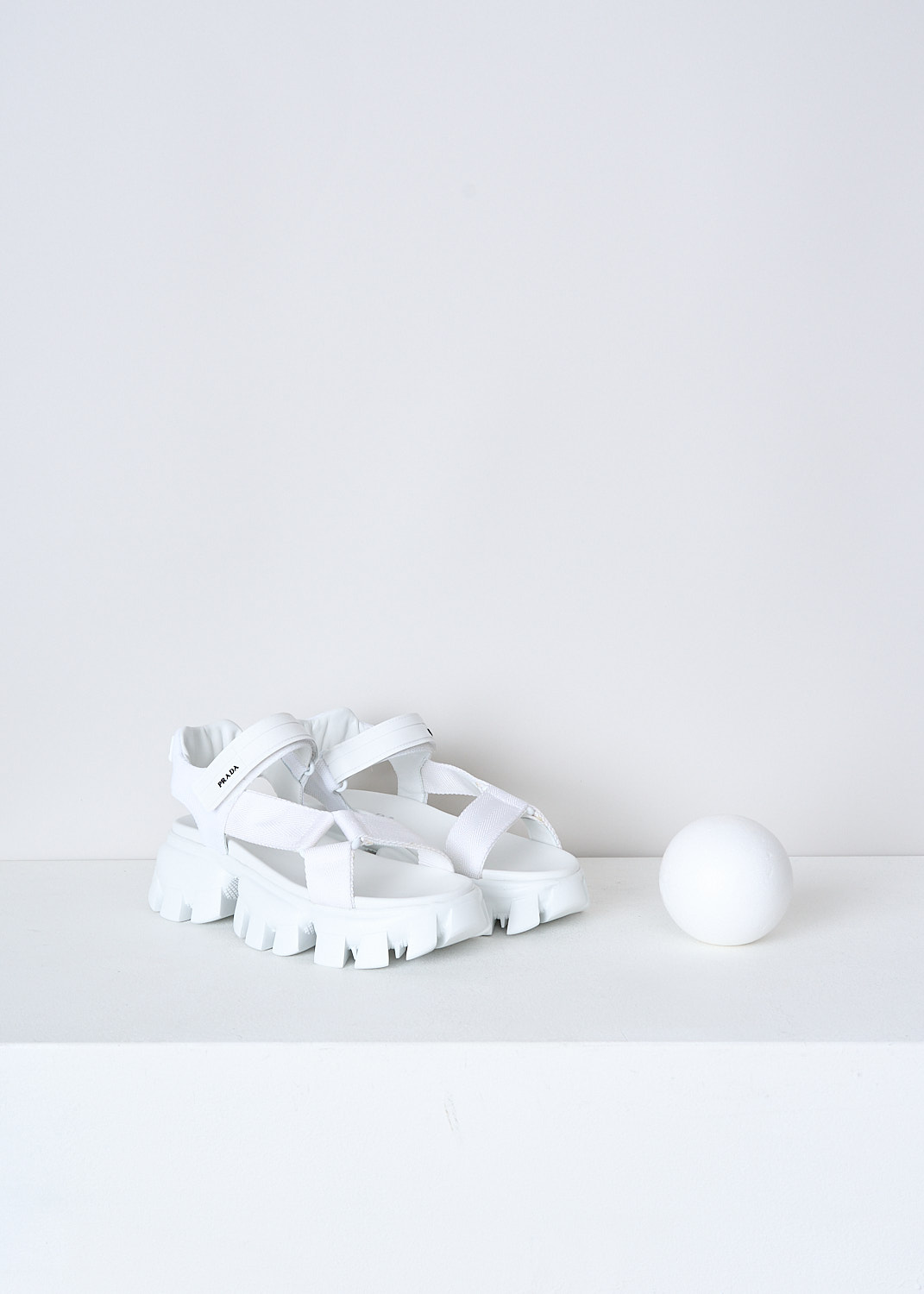 PRADA, WHITE SANDALS WITH CHUNKY SOLES, 1X037M_3L6W_F0009_NASTRO_MAGLIA_BIANCO, White, Front, These white sporty sandals have an adjustable velcro ankle strap with the brand's logo on in in black and white fabric straps across the vamp. These sandals have a round open-toe and chunky ridged soles. 
