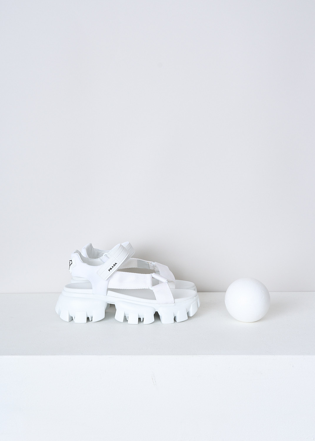 PRADA, WHITE SANDALS WITH CHUNKY SOLES, 1X037M_3L6W_F0009_NASTRO_MAGLIA_BIANCO, White, Side, These white sporty sandals have an adjustable velcro ankle strap with the brand's logo on in in black and white fabric straps across the vamp. These sandals have a round open-toe and chunky ridged soles. 
