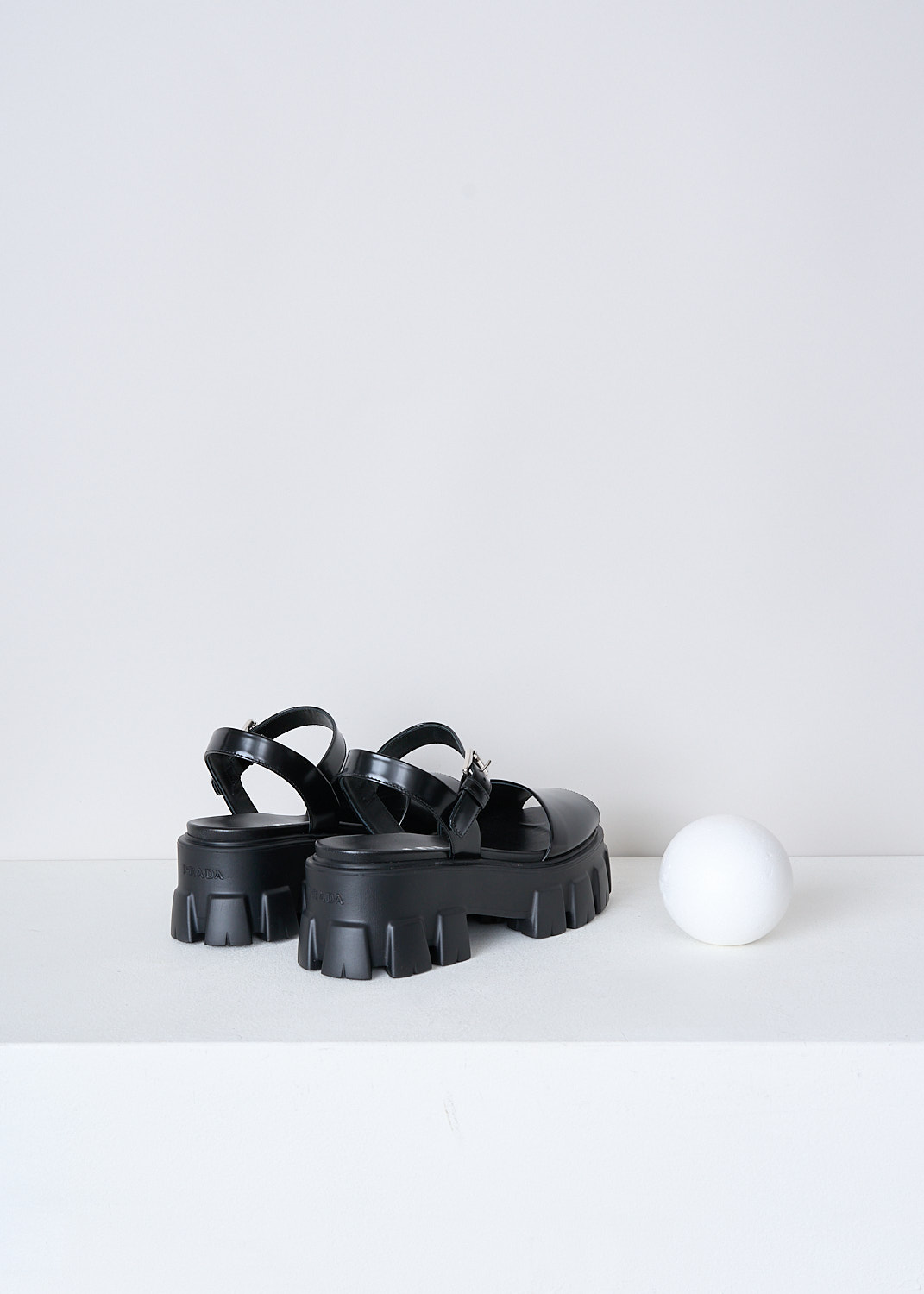 PRADA, BLACK CHUNKY PLATFORM SANDALS, 055_SPAZZOLATO_1X526M_F0002_NERO, Black, Back, These black leather platform sandals have an adjustable ankle strap with a silver-tone buckle. These sandals have a broad strap across the vamp, a round open-toe and chunky ridged soles. 

