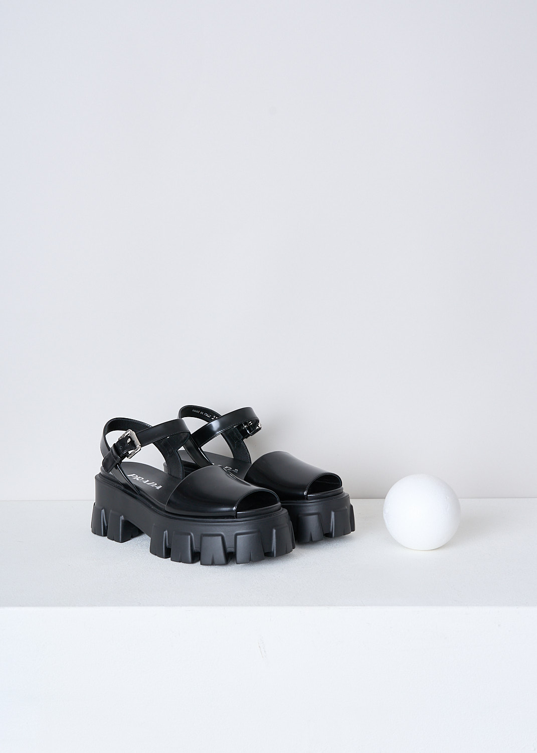 PRADA, BLACK CHUNKY PLATFORM SANDALS, 055_SPAZZOLATO_1X526M_F0002_NERO, Black, Front, These black leather platform sandals have an adjustable ankle strap with a silver-tone buckle. These sandals have a broad strap across the vamp, a round open-toe and chunky ridged soles. 

