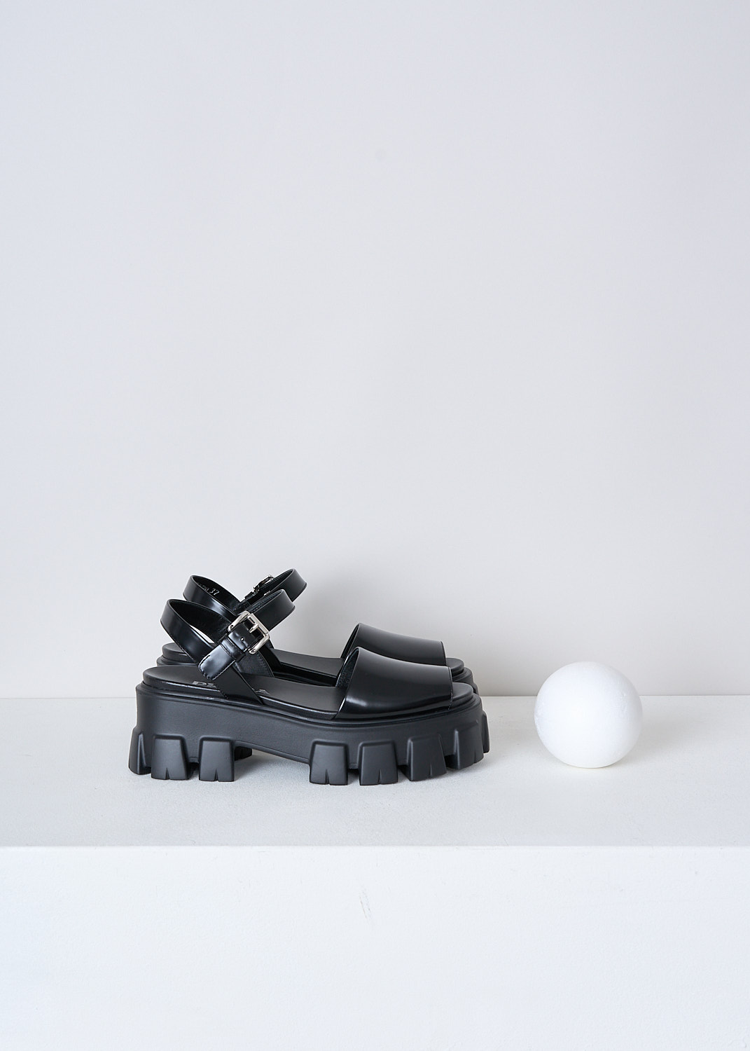 PRADA, BLACK CHUNKY PLATFORM SANDALS, 055_SPAZZOLATO_1X526M_F0002_NERO, Black, Side, These black leather platform sandals have an adjustable ankle strap with a silver-tone buckle. These sandals have a broad strap across the vamp, a round open-toe and chunky ridged soles. 

