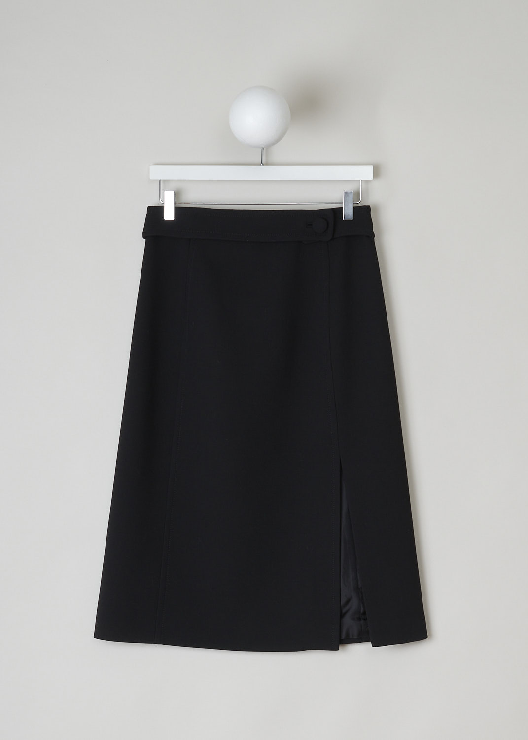 PRADA, BLACK A-LINE MIDI SKIRT, P113H_GUL_F0002_NATTE_GONNA_NERO, Black, Back, This black wool midi skirt has an A-line silhouette. In the back, on the broad waistband, the skirt has an incorporated belted detail with a big round fabric button. Also in the back, the skirt has a side slit and a concealed zipper that functions as the closure option. The skirt is fully lined.

