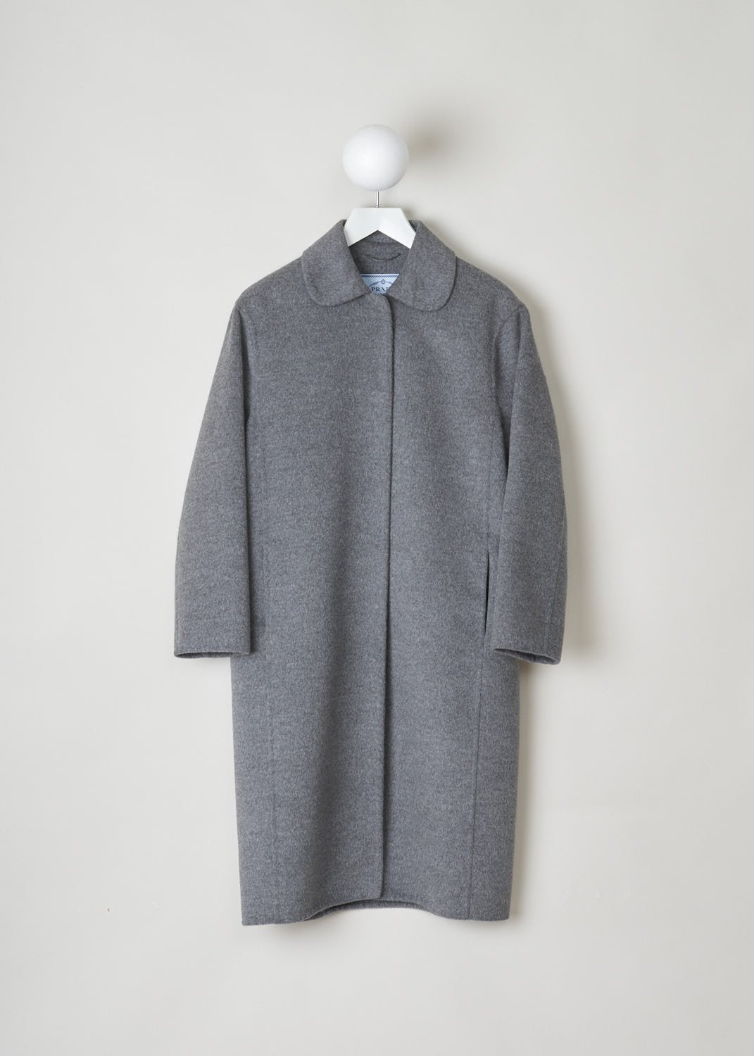 PRADA, GREY WOOL COAT WITH CLAUDINE COLLAR, P650E_03H_Cashgora_Double_F0031_Grigio, Grey, Front, This grey wool-blend coat has a Claudine collar and a concealed press-button closure. Concealed slanted pockets can also be found on the front of the coat. In the back, the coat has a pleated yoke and a martingale.
