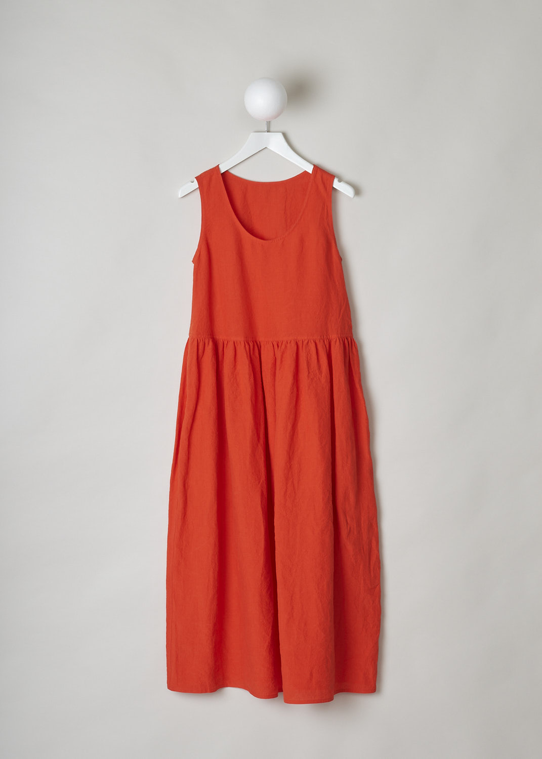 SOFIE D’HOORE, BRIGHT RED LINEN DRESS, DANDLE_LIFE_RED_PEPPER, Red, Front, This bright red sleeveless dress has U-neckline. The dress has a wide A-line silhouette. A straight crystal pleated hemline separates the bodice from the midi length skirt. Concealed slanted pockets can be found in the side seam. 
