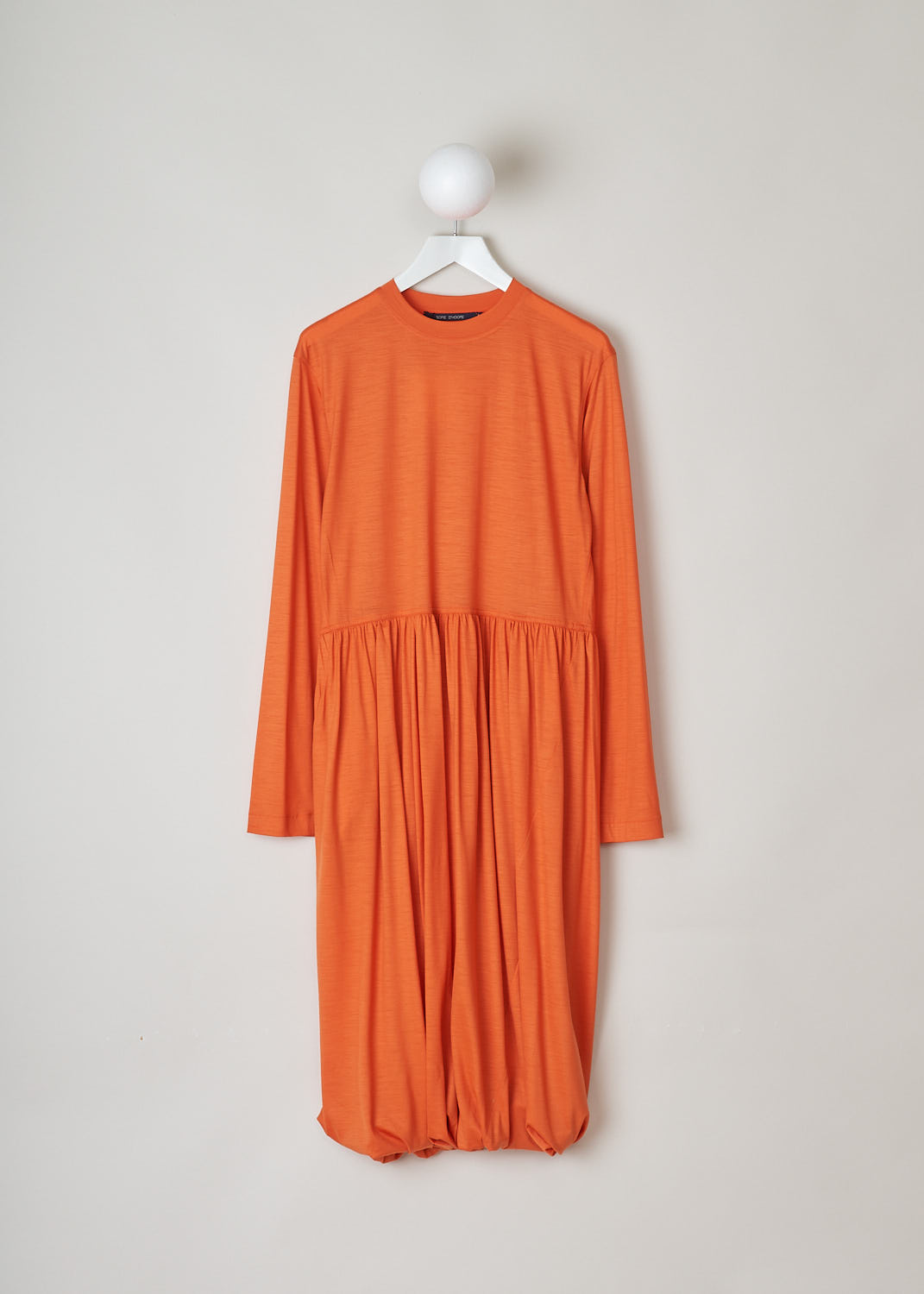 SOFIE D’HOORE, ORANGE LONG SLEEVE DRESS, DEMURE_WOJE_PAPAYA, Orange, Front, This orange mid-length dress features a round neckline, a plain long sleeve bodice and a twisted balloon skirt. A single side pocket can be found concealed in the seam. 
