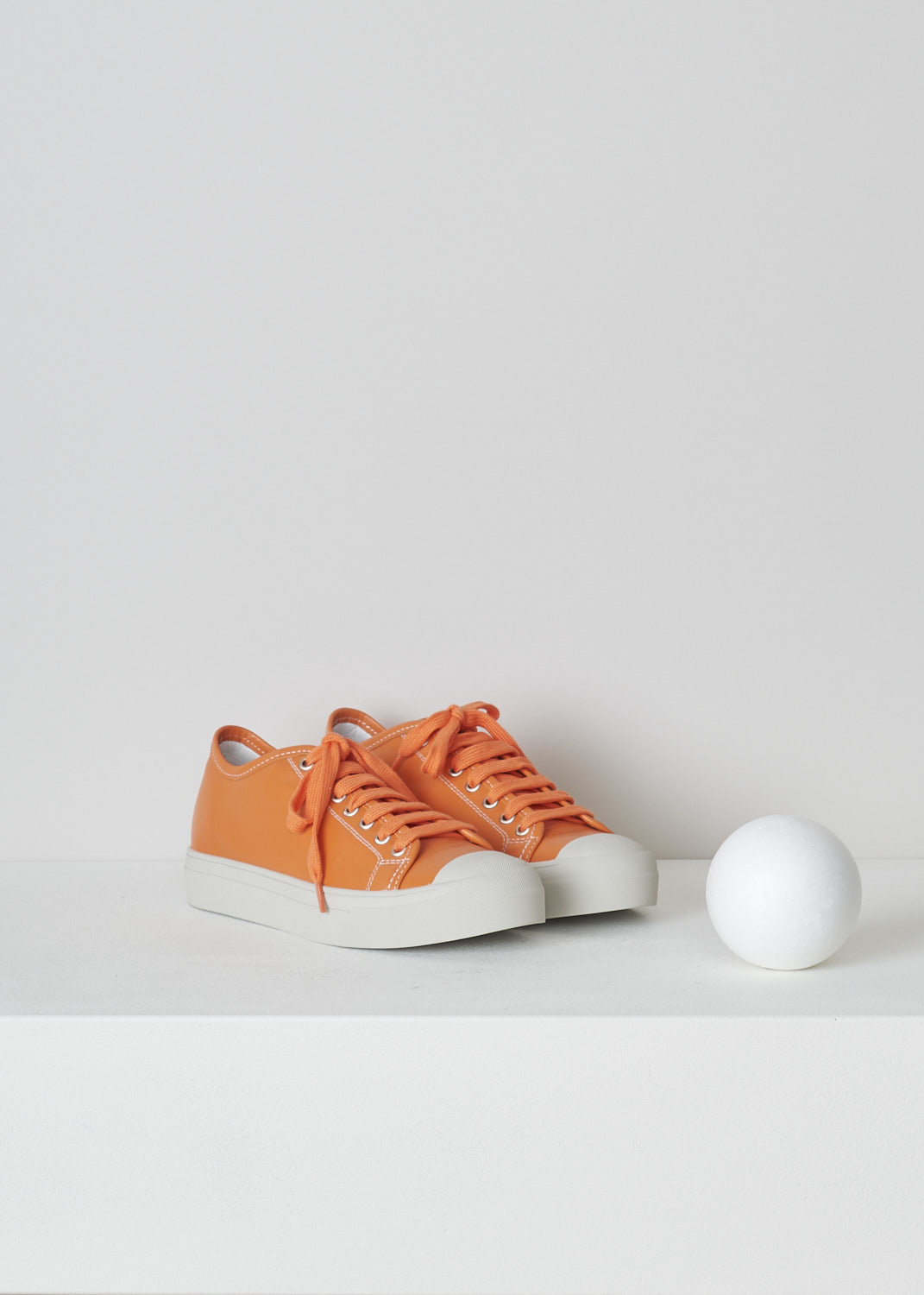 SOFIE Dâ€™HOORE, ORANGE LEATHER SHOES, FOLK_LMAST_LMAST_ORANGE, Orange, Front, These orange leather sneakers feature a front lace-up closure with orange laces. These sneakers have a round toe with a white rubber toe cap that goes down into the white rubber sole. Contrasting white stitching is used throughout. The sneakers come with an additional pair of white laces.
