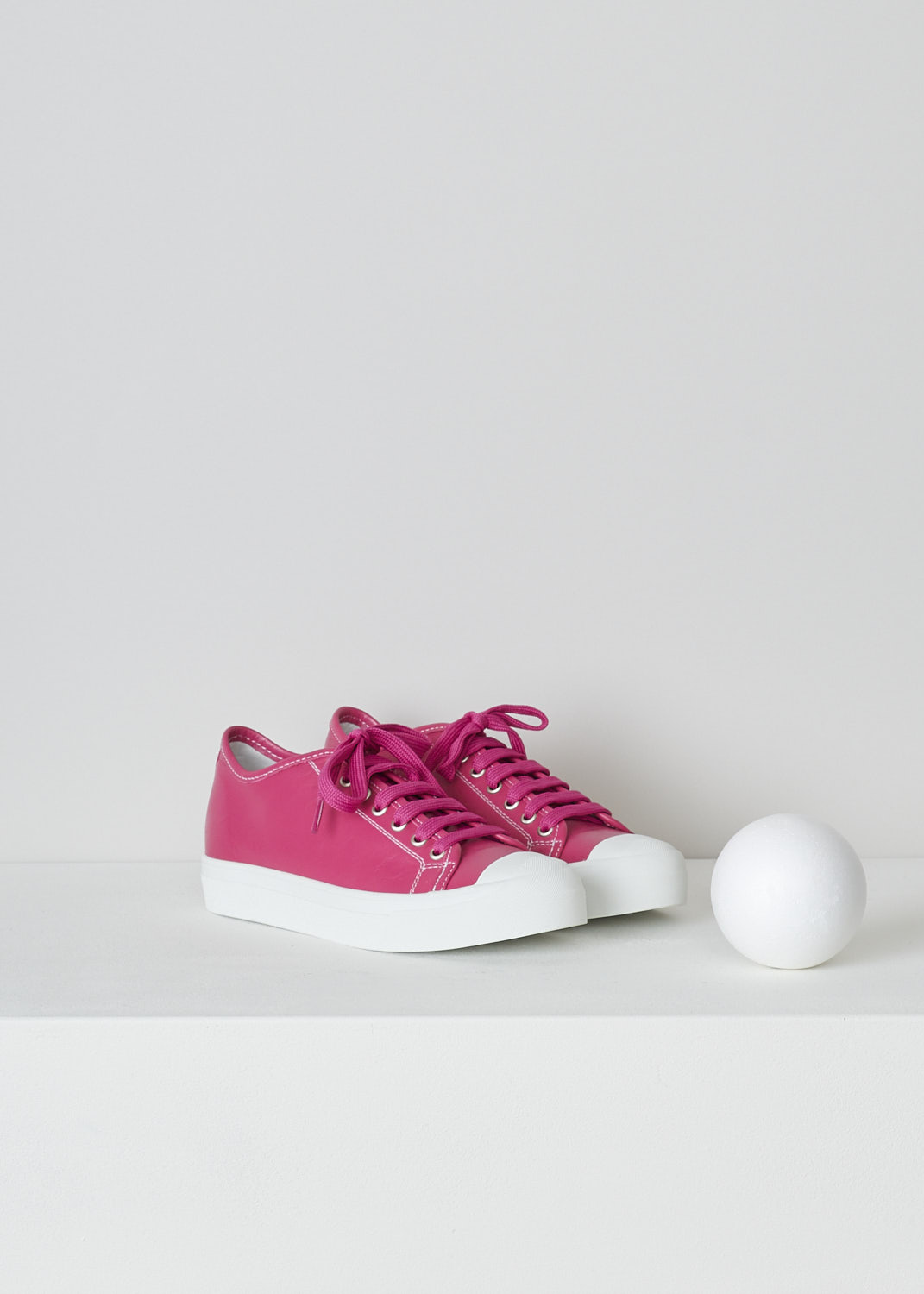 SOFIE Dâ€™HOORE, FUCHSIA PINK LEATHER SHOES, FOLK_LSNOW_FUCHSIA, Pink, Front, These fuchsia pink leather sneakers feature a front lace-up closure with pink laces. These sneakers have a round toe with a white rubber toe cap that goes down into the white rubber sole. Contrasting white stitching is used throughout. The sneakers come with an additional pair of laces in white.
