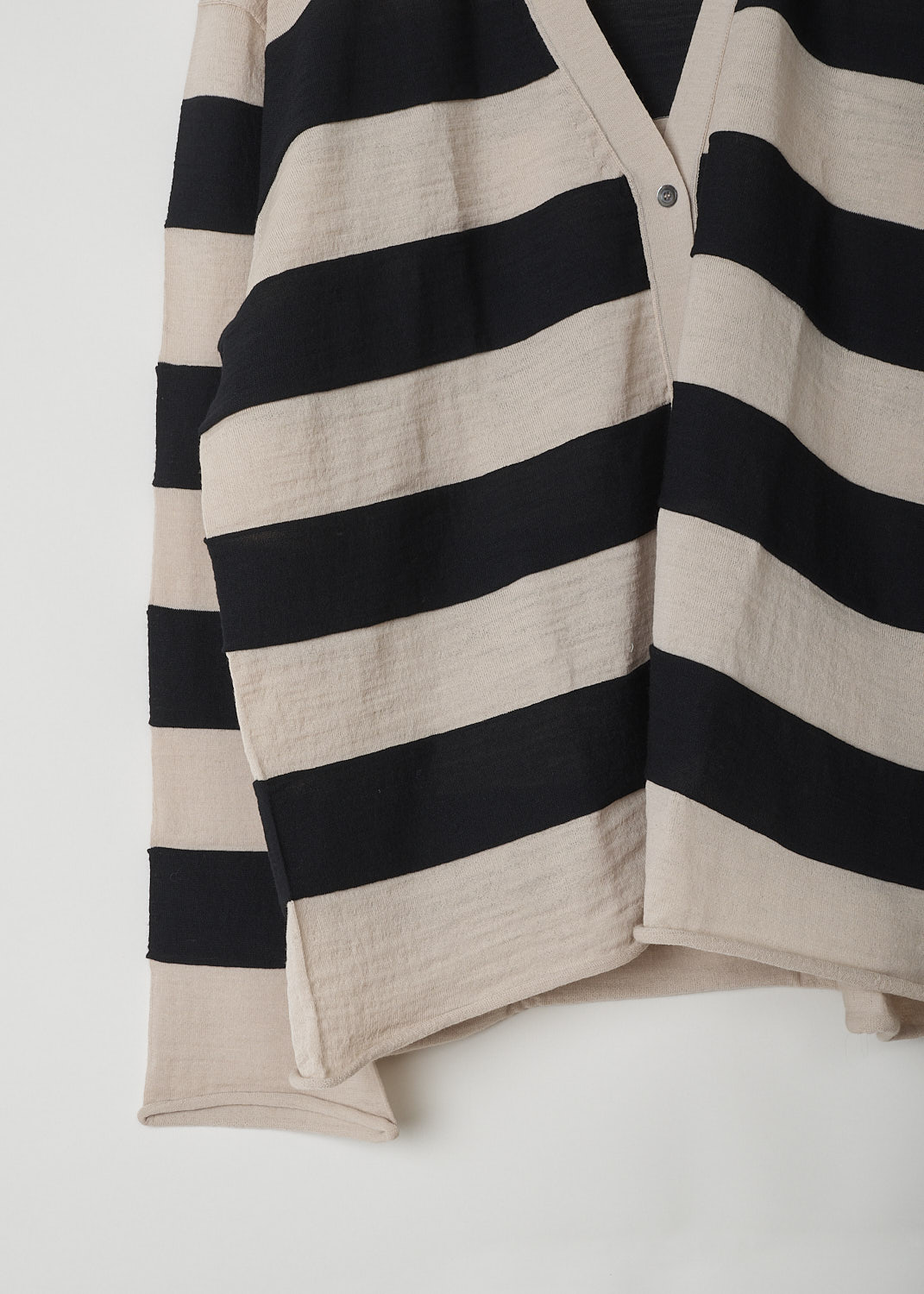 SOFIE D’HOORE, BEIGE AND BLACK STRIPED CARDIGAN, MANIA_YFIMBI_SAAND_BLACK, Beige, Black, Detail, This beige and black striped wool cardigan has a V-neckline and a front button closure. The cuffs and hemline have a rolled hemline. The cardigan has a wider silhouette. 
