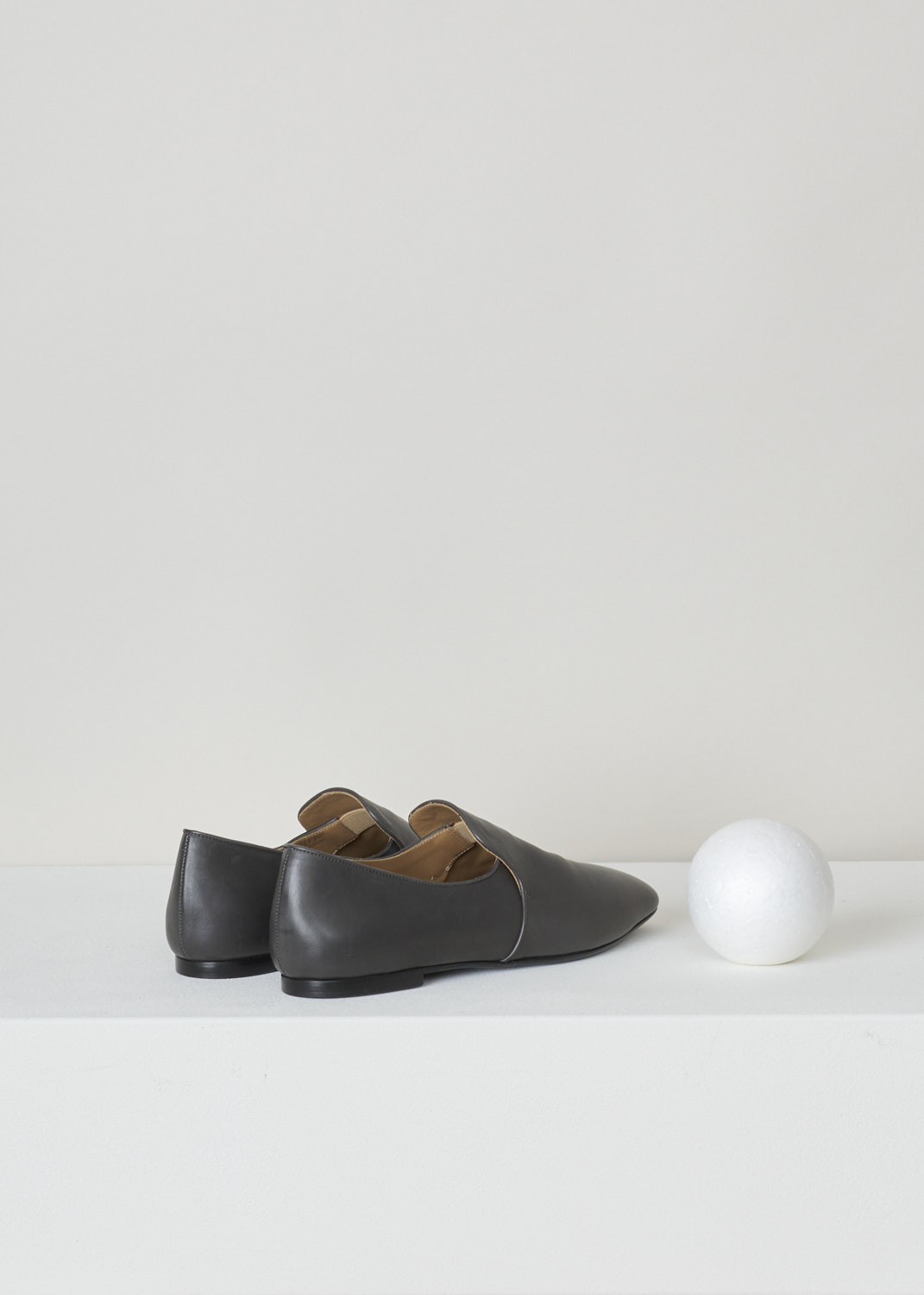 The Row, Charcoal coloured leather alys slipper, F1005_L64_COL, grey, back, Made from a minimalist perspective, and crafted out of butter-soft calfskin. Featuring a rounded toe vamp and comes with grey satin piping on the topline. The seamless lining ensures they can be worn with or without socks.