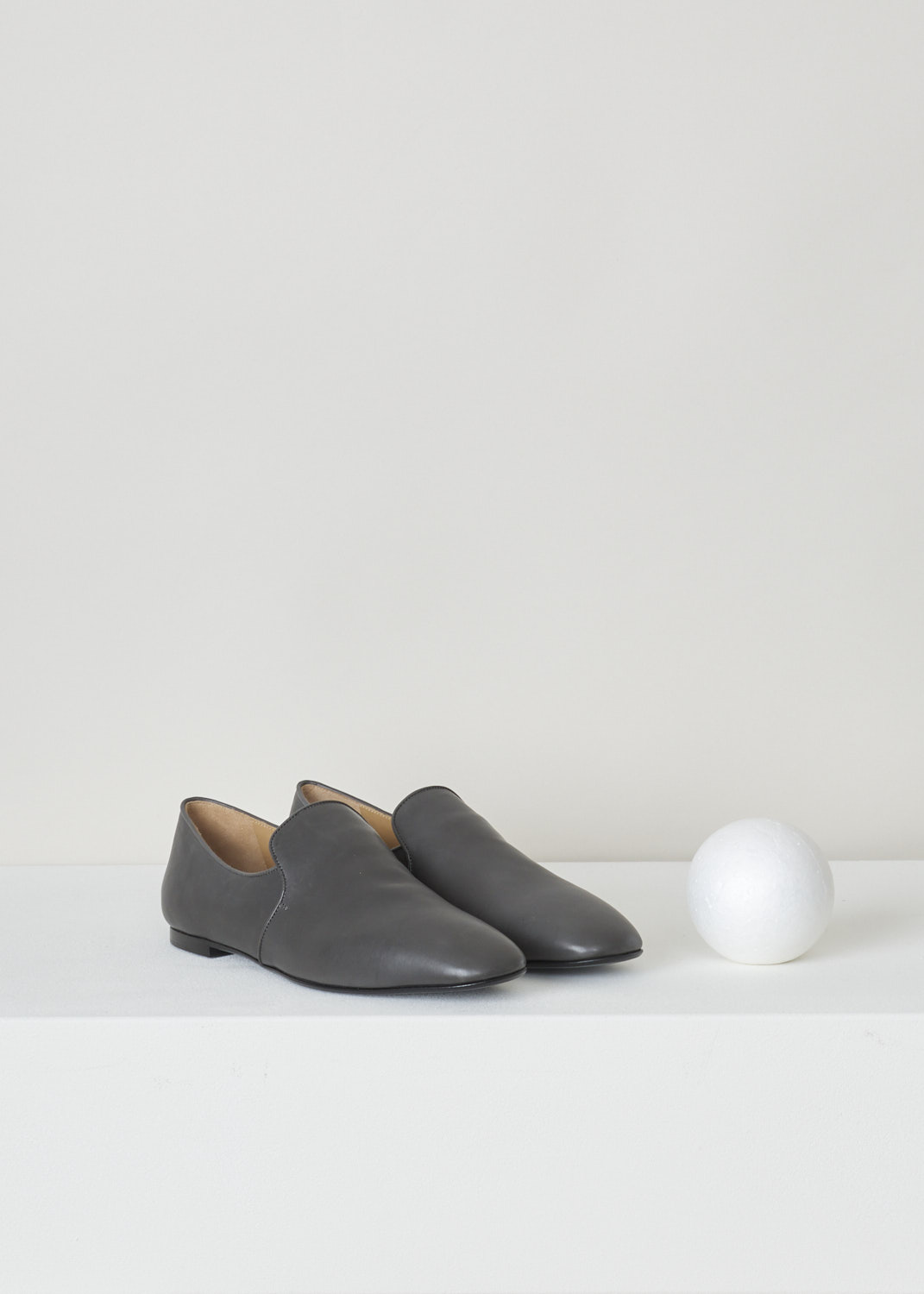The Row, Charcoal coloured leather alys slipper, F1005_L64_COL, grey, front, Made from a minimalist perspective, and crafted out of butter-soft calfskin. Featuring a rounded toe vamp and comes with grey satin piping on the topline. The seamless lining ensures they can be worn with or without socks.