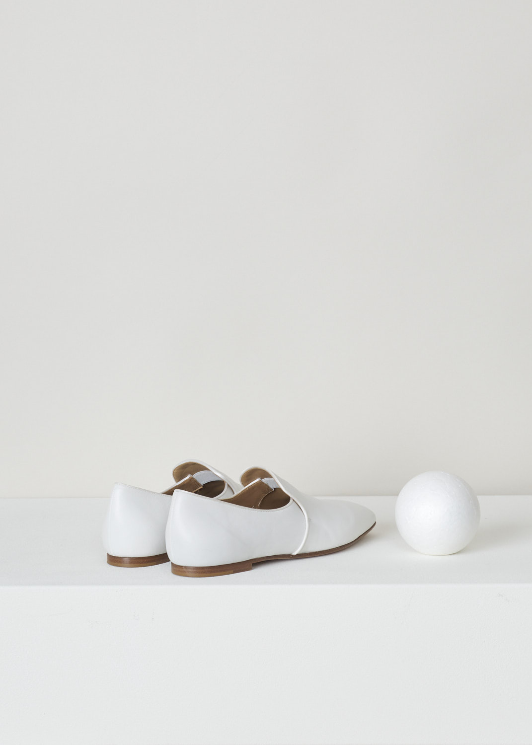 The Row, White leather alys slipper, F1005_L64_WHT, white, back, Made from a minimalist perspective, and crafted out of butter-soft calfskin. Featuring a rounded toe vamp and comes with white satin piping on the topline. The seamless lining ensures they can be worn with or without socks.