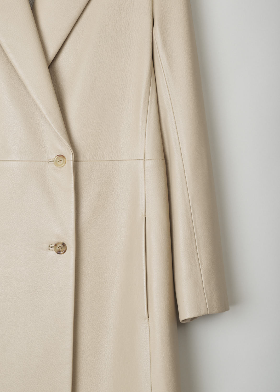 THE ROW, BEIGE LEATHER COAT, GERRICK_I_6I_8L79_SOAPSTONE, Beige, Detail, This beautiful double breasted coat has peaked lapels. A decorative, horizontal seam can be found across the front. The coat has two concealed slanted pockets on either side. 
