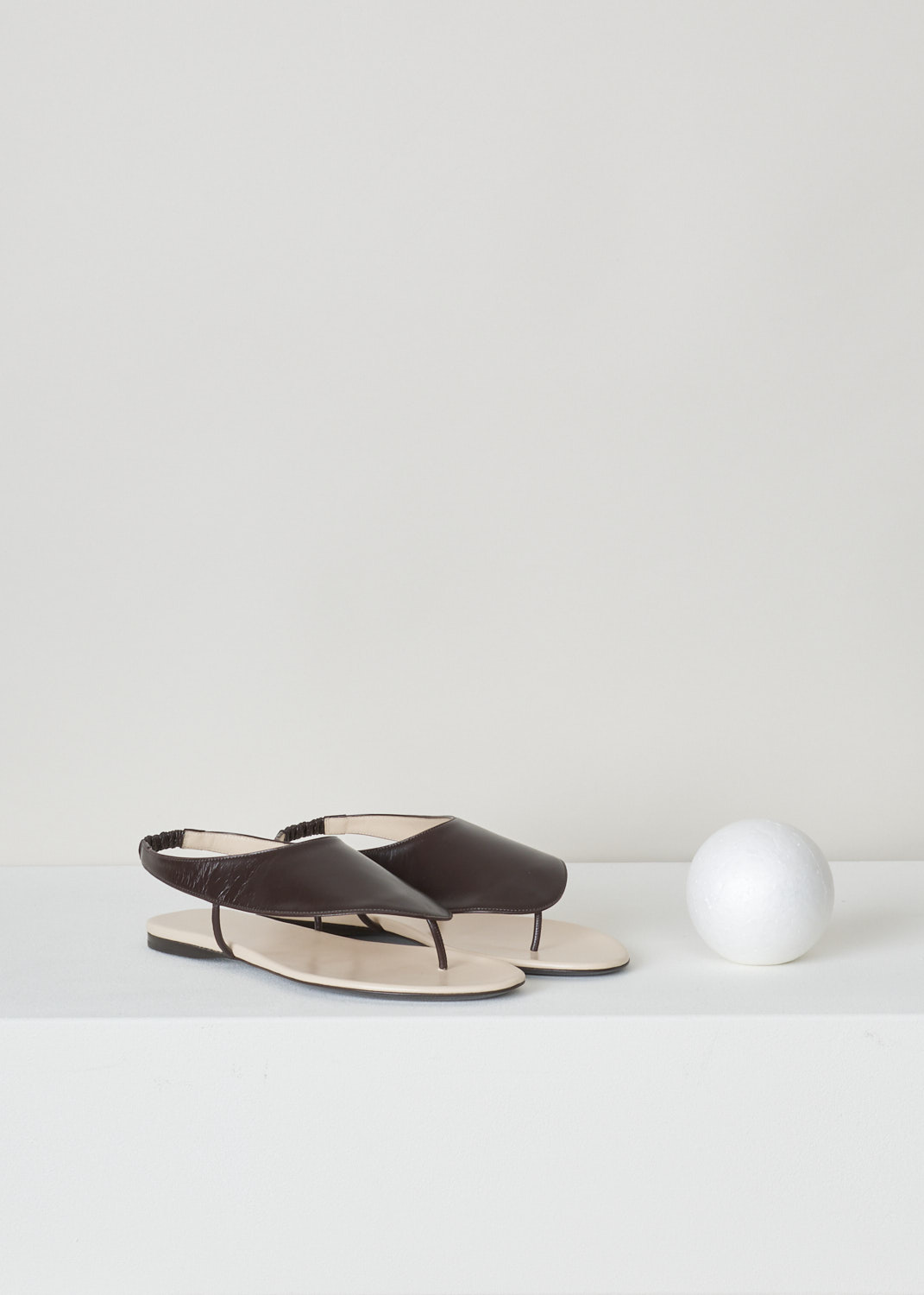 The Row, Dark brown ravello thong sandal, F1155_L35_DBR, brown, front, Ravelo slip-on sandals from The Row. Coloured to a lovely shade of dark brown. Featuring a round and open toe vamp and comes with an elastic slingback strap. 