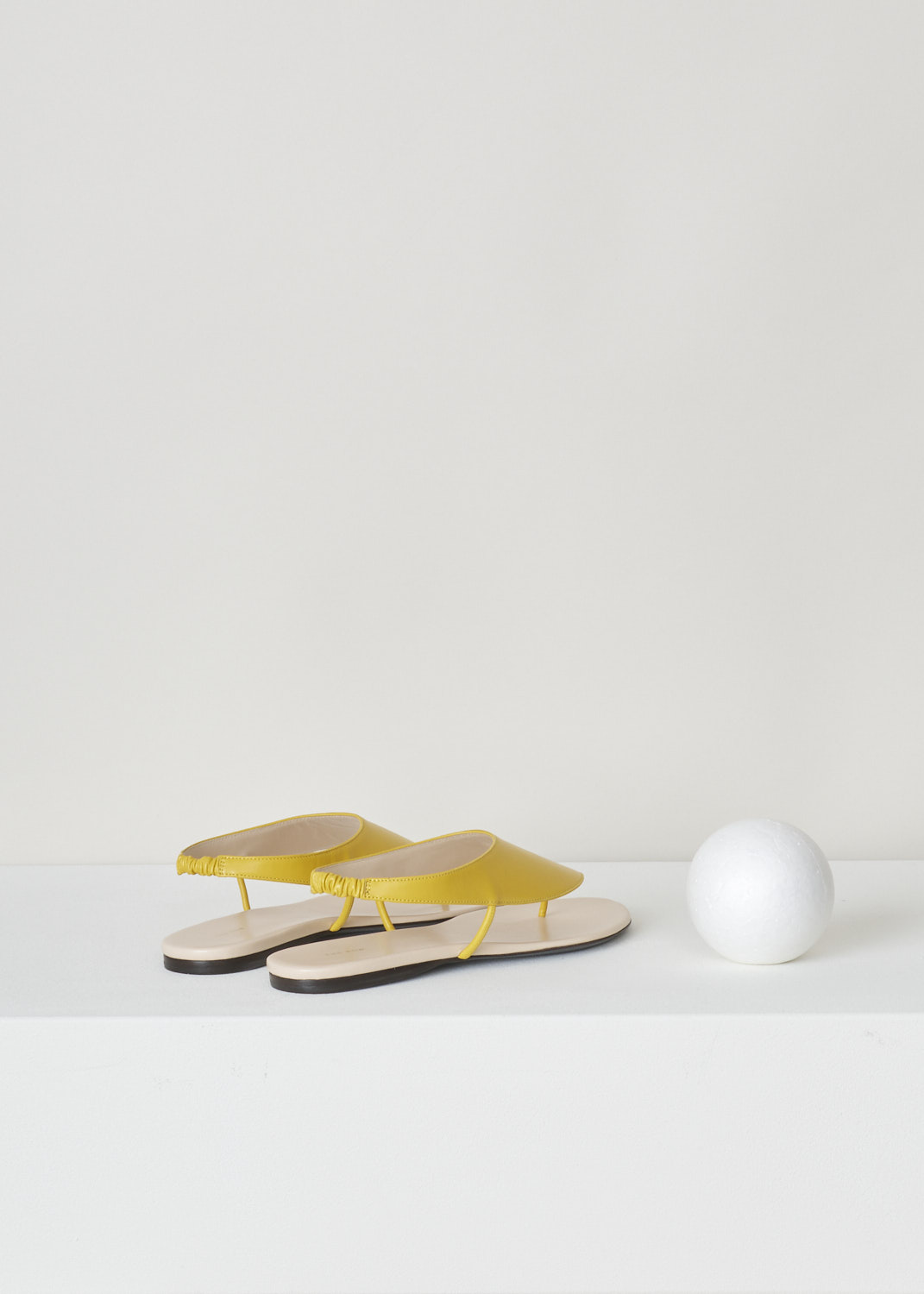 The Row, Mustard yellow ravello thong sandal, F1155_L35_MUS, yellow, back, Ravelo slip-on sandals from The Row. Coloured to the lovely shade of mustard yellow. Featuring a round and open toe vamp and comes with an elastic slingback strap. 