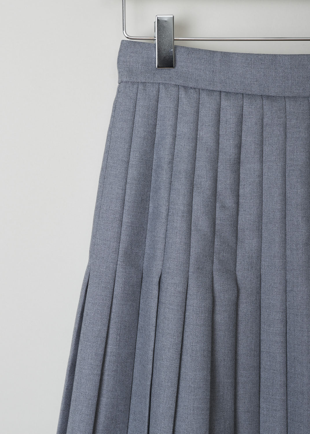THOM BROWNE, BELOW THE KNEE GREY PLEATED SKIRT, FGC513A_02055_035_MED_GREY, Grey, Detail, Grey pleated skirt reminiscent of a school uniform. This circle skirt has knife pleats throughout. It has a concealed zip and clasp on the side seam. In the back, the grosgrain pull tab can be found. 
