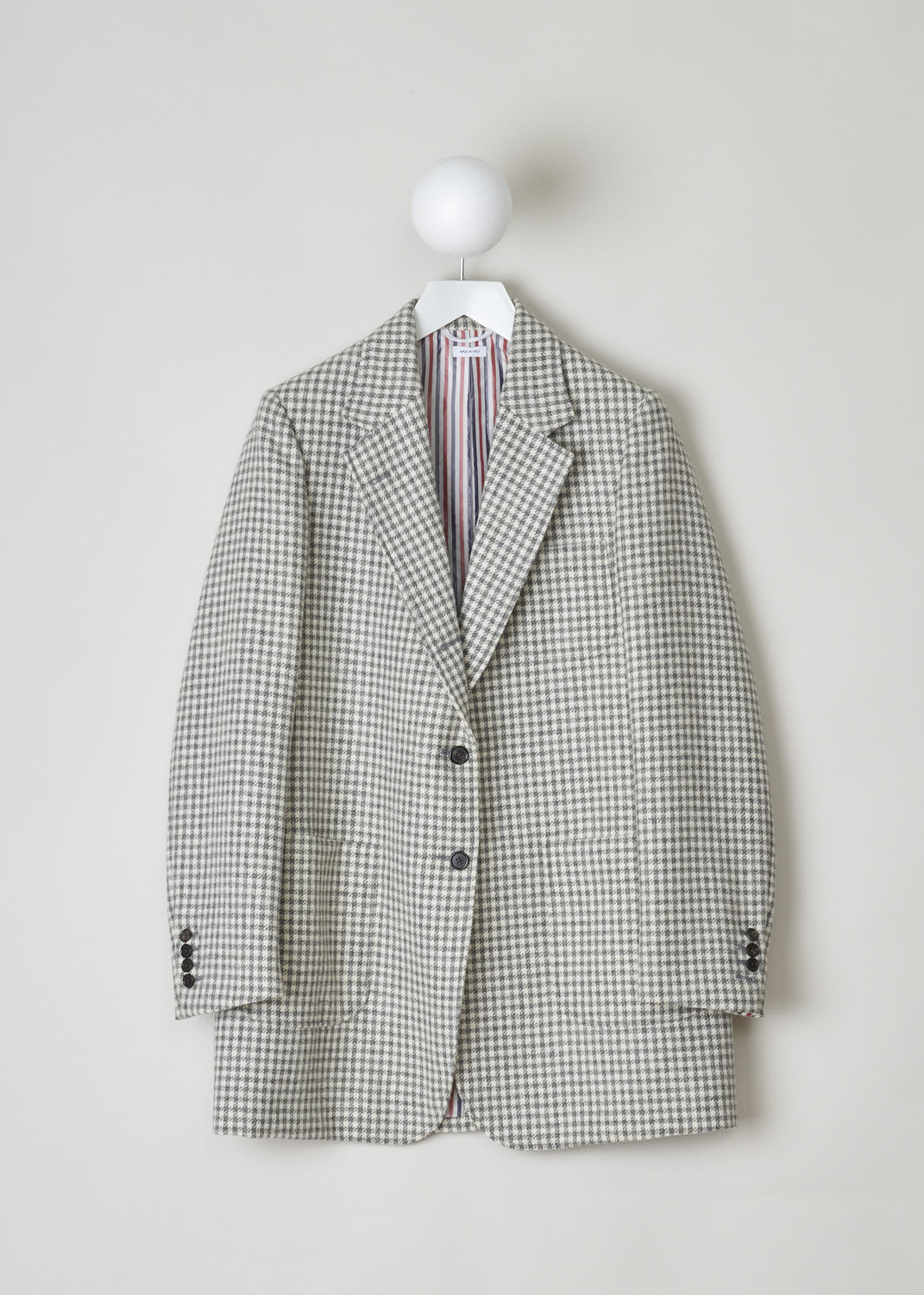 THOM BROWNE, OVERSIZED BLAZER IN HOUNDSTOOTH, FBC500A_06842_035_MED_GREY, Print, Front, Classic Houndstooth printed oversized blazer. This single breasted blazer features a notched lapel and a front button closure. The blazer has a single chest pocket, two patch pockets and three inner pockets. The long sleeves have buttoned cuffs. In the back, a centre slit can be found. 
