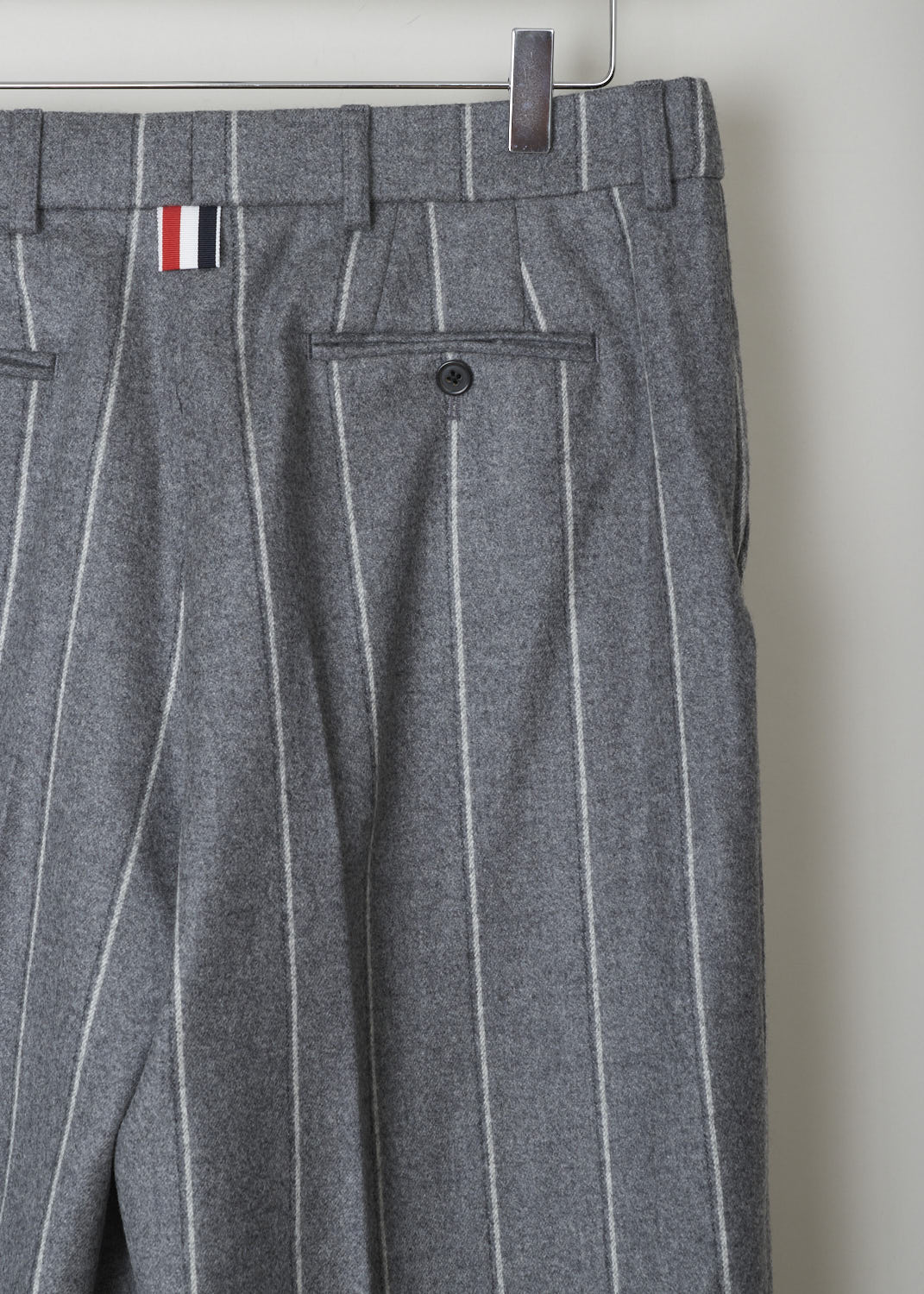 THOM BROWNE, WOOL FLANNEL STRIPED TROUSERS, FTC160A_05019_035_MED_GREY, Grey, Print, Detail, These heather grey, striped trousers have belt loops and a clap a zip closure They feature slanted pockets in the front and buttoned welt pockets in the back. The pant legs end in broad, folded hem. 
