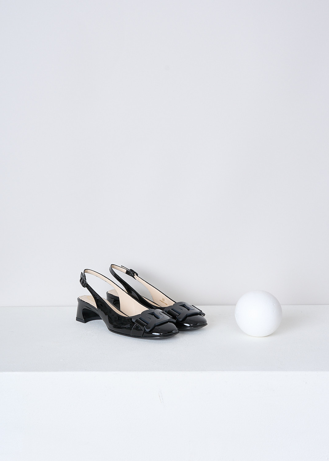 TODS, BLACK LACQUER SLINGBACKS, XXW85C0EC10SFKB999, Black, Front, These black lacquer slingbacks have an adjustable ankle strap. The  pumps have a closed round nose with an exaggerated black chain detail with the brand's logo debossed on the front.
