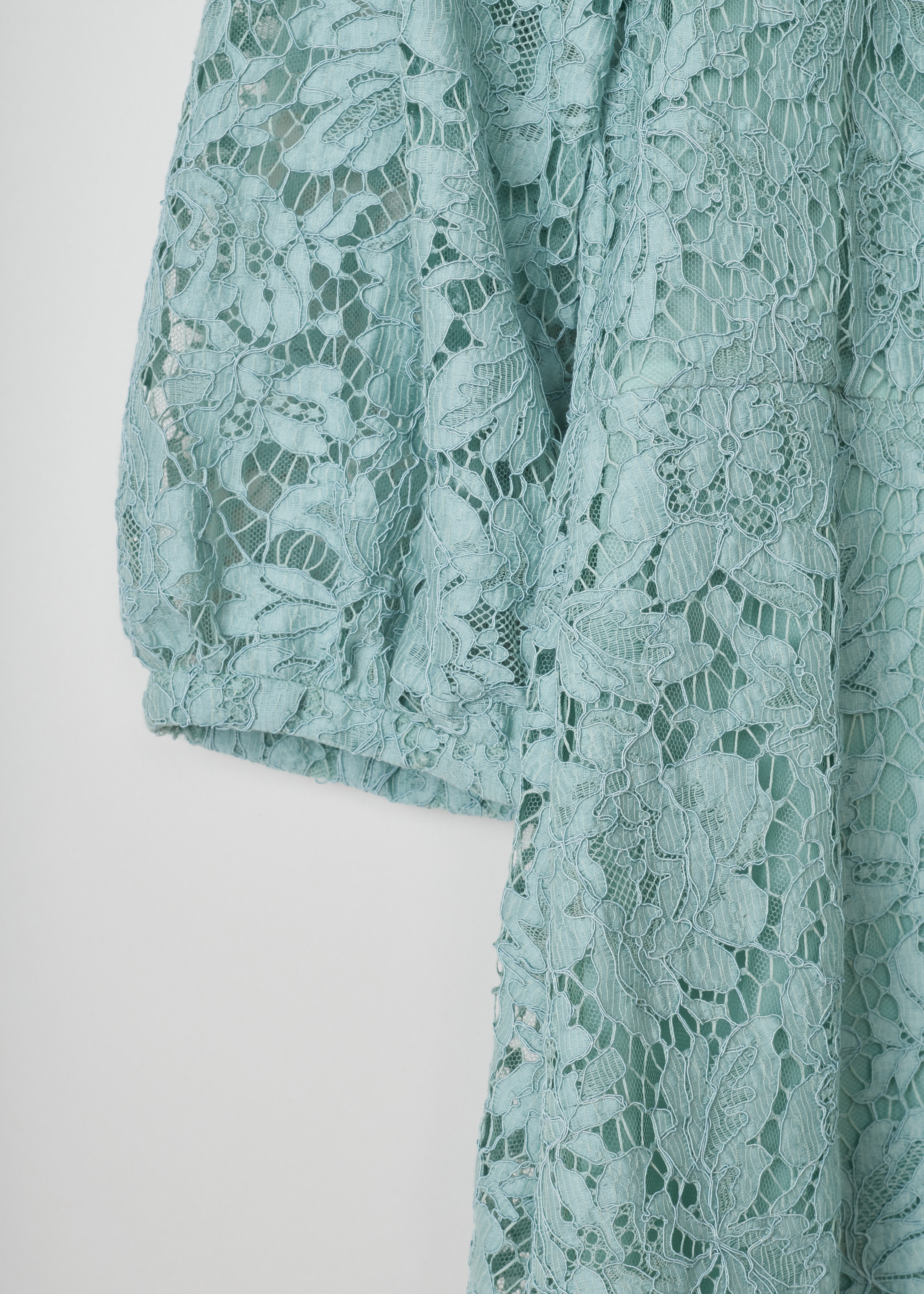 Valentino pastel green long sleeve lace dress RB0VALH71EC_5W0 light blue detail. Pastel green dress in cotton lace, bishop sleeves, a fitted bodice with a close-fit neckline, an a-line skirt, scalloped hems and an invisible zip fastening on the back.