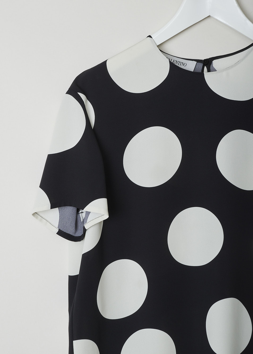 VALENTINO, BLACK TOP WITH BIG WHITE DOTS, VB3AE5P5661_0NA, Black, White, Print, Detail, This boxy silk top has a black base with a big dotted print in white.  The top has a high, round neckline and short sleeves. In the back, a single button with keyhole functions as the closure option. The top has a wider silhouette.
