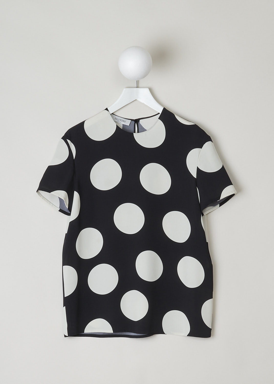 VALENTINO, BLACK TOP WITH BIG WHITE DOTS, VB3AE5P5661_0NA, Black, White, Print, Front, This boxy silk top has a black base with a big dotted print in white.  The top has a high, round neckline and short sleeves. In the back, a single button with keyhole functions as the closure option. The top has a wider silhouette.
