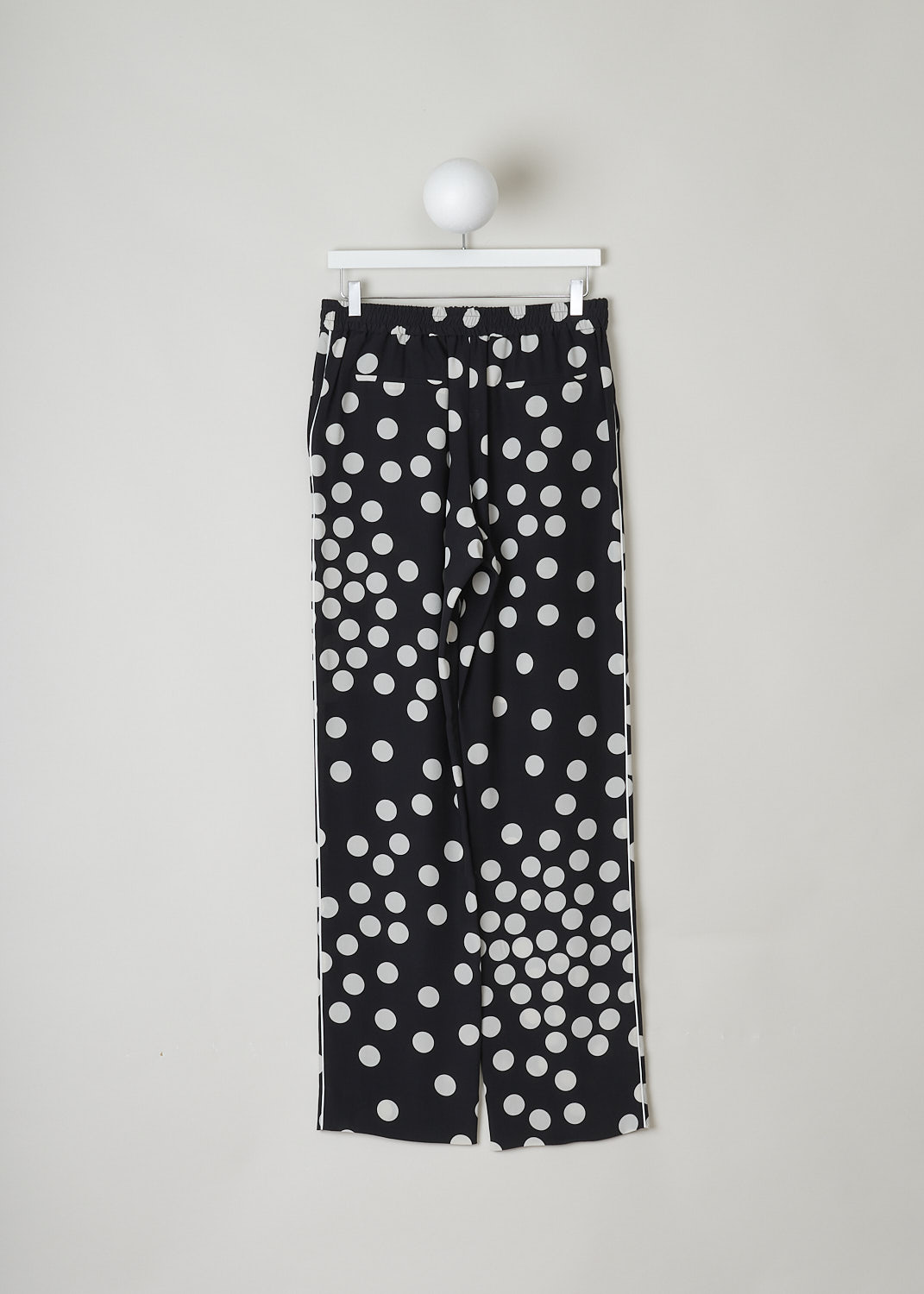 VALENTINO, HIGH WAISTED BLACK PANTS WITH WHITE DOTS, VB3RB43565N_0NA, Black, White, Print, Back, These high waisted black silk pants have an irregular doted print in white. These slip-on pants have an elasticated waistline with a drawstring on the inside. The straight, ankle length pant legs have white piping along side seams. In the front, these pants have slanted pockets and in the back welt pockets can be found.
