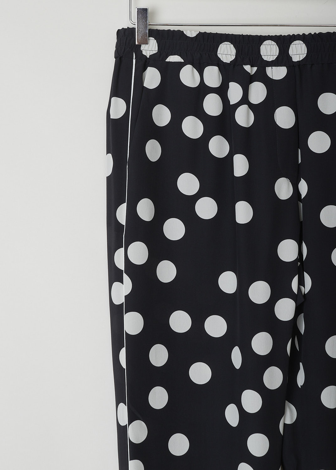 VALENTINO, HIGH WAISTED BLACK PANTS WITH WHITE DOTS, VB3RB43565N_0NA, Black, White, Print, Detail, These high waisted black silk pants have an irregular doted print in white. These slip-on pants have an elasticated waistline with a drawstring on the inside. The straight, ankle length pant legs have white piping along side seams. In the front, these pants have slanted pockets and in the back welt pockets can be found.

