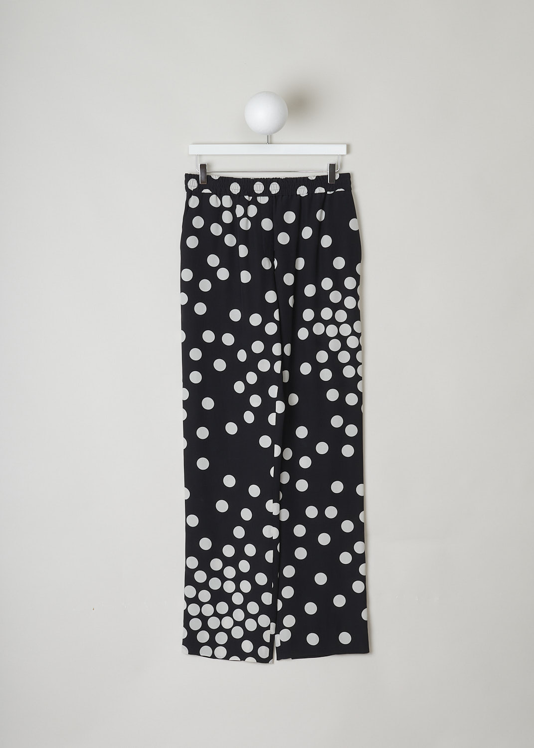 VALENTINO, HIGH WAISTED BLACK PANTS WITH WHITE DOTS, VB3RB43565N_0NA, Black, White, Print, Front, These high waisted black silk pants have an irregular doted print in white. These slip-on pants have an elasticated waistline with a drawstring on the inside. The straight, ankle length pant legs have white piping along side seams. In the front, these pants have slanted pockets and in the back welt pockets can be found.
