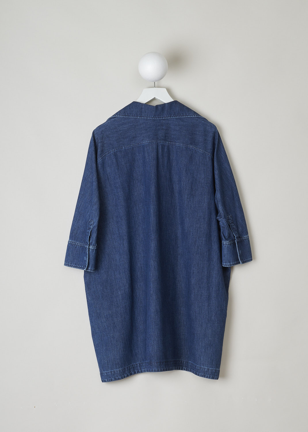 VALENTINO, DARK WASH DENIM TUNIC, XB3DB01I433_558XB3DB01I433_558, Blue, Back, This wide tunic in a darker wash jean fabric has a spread collar with a V-neckline. The end of the V-neck is decorated with the brands signature V. The tunic has three-quarter raglan sleeves with buttoned cuffs. Slanted pockets can be found concealed in the side seams. The tunic has an asymmetrical finish, meaning the back is a little longer than the front. Small slits can be found on either side. 
