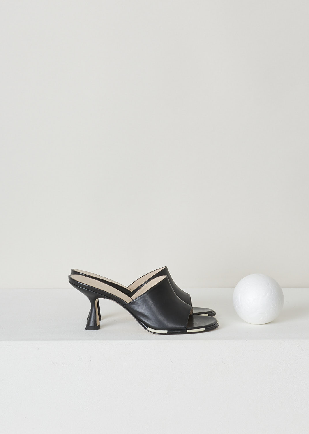 WANDLER, BLACK HEELED MULES, 22202_701204_3248_AGNES_MULE_BLACK_MIX, Black, Side, These black heeled mules have a rounded open-toe with contrasting white stripes decorating the trim. The slip-on mules have a mid-height trapezoid shaped heel.
