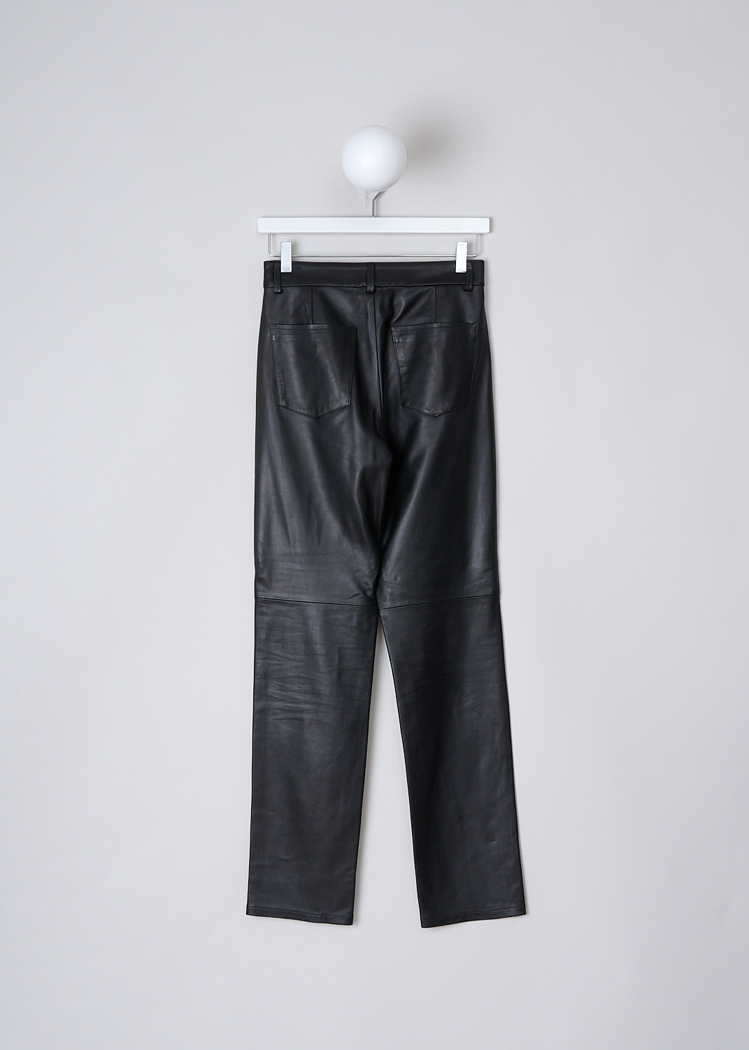 WANDLER, CARNATION LONG BLACK LEATHER PANTS, 22306_100301_3200_CARNATION_LONG_BLACK, Black, Back, These black leather Carnation Long pants have a waistband with belt loops and a button and zip closure. The pants have a high-waisted fit with tapered pant legs. A decorative horizontal seam can be found below the knee. These pants have slanted pockets in the front and patch pockets in the back. 
